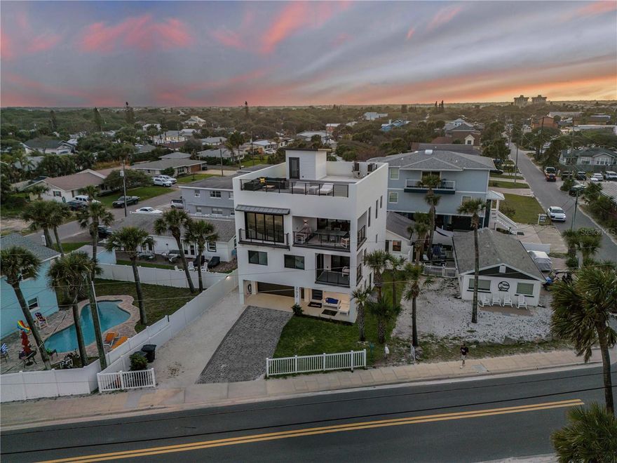 Experience elevated coastal living in this exceptional ocean-view property in New Smyrna Beach. Spanning over 4,400 total square feet, this unique offering includes two residences with a combined 7 bedrooms and 5.5 bathrooms, a private pool, and an unbeatable location just moments from the beach, dining, and shopping. Situated in a highly desirable short-term rental zone, this property presents incredible flexibility and income potential. The main home features a stunning rooftop deck with panoramic Atlantic Ocean views and a private elevator providing seamless access to all levels. Live in one residence while generating revenue from the other, or continue operating as a turnkey vacation rental investment. Designed with a modern coastal aesthetic, both homes showcase open-concept layouts, abundant natural light, and stylish finishes throughout. Spacious bedrooms provide a comfortable retreat, many with beautiful water views and inviting coastal ambiance. Outdoors, enjoy a private pool and multiple entertaining areas, perfect for relaxing or hosting guests. Take in ocean breezes, breathtaking sunrises, and the soothing sound of the waves from multiple vantage points, including the expansive rooftop deck. Ideally located within walking or golf cart distance to all that New Smyrna Beach has to offer, this property provides easy access to pristine beaches, local restaurants, boutique shopping, and a variety of outdoor activities. Whether you're seeking a primary residence, vacation home, or high-performing investment, this rare opportunity delivers the best of luxury, location, and lifestyle. Schedule your private showing today!