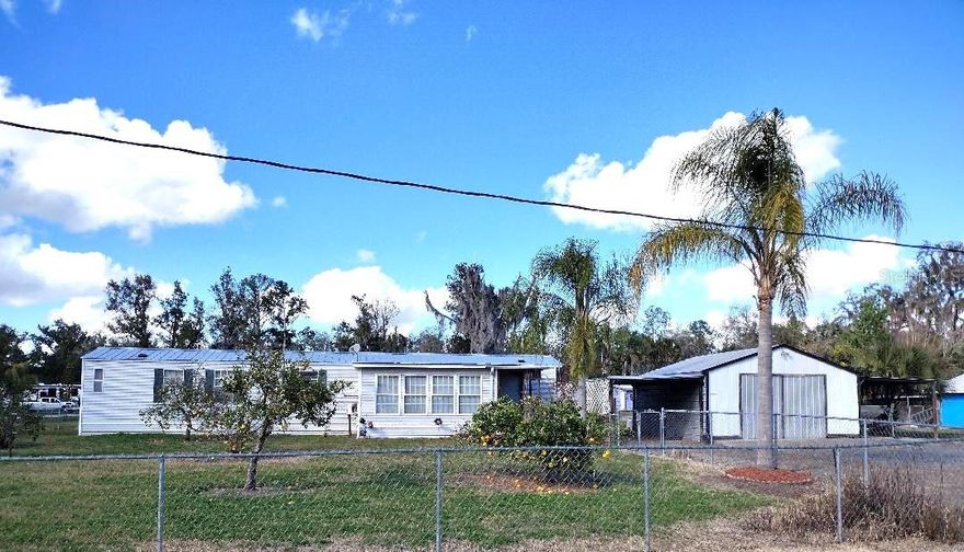 Looking for an affordable Florida home in a quiet country setting? This well-maintained 2 bedroom, 2 bath singlewide mobile home offers comfort, functionality, and outdoor space just minutes from Dead Lake/ Bull Creek—perfect for fishing, boating, and enjoying the natural beauty of Flagler County.
Inside, you’ll find a spacious layout featuring an enclosed front porch for additional living space and a back screened-in porch ideal for relaxing evenings without the bugs. The home has been well cared for and is move-in ready, making it a great option for full-time living, a weekend retreat, or even an investment property
The fenced yard offers privacy and space for pets, gardening, or outdoor entertaining. The workshop provides room for tools and projects, while the carport and lean-to provide covered parking for vehicles and your boat.
Conveniently located near Dead Lake (Bull Creek), you’ll enjoy easy access to freshwater recreation while still being within driving distance to shopping, medical facilities, and major roadways.
If you're searching for an affordable home near Dead Lake with room to store your boat and have workshop space, this property checks all the boxes.