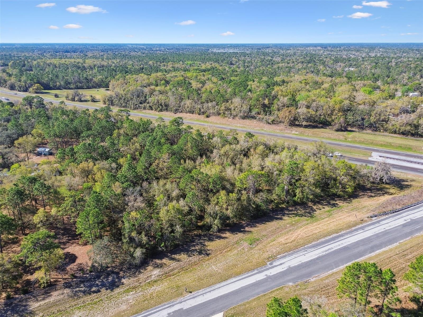 NEW LOWER PRICE! Discover the potential of this 3-acre agricultural-zoned property for those looking for space and freedom. This vacant land offers incredible flexibility for a variety of uses—whether you are looking to build a home, start a small ranch, have some livestock, bring your big toys, or create a garden oasis.
Situated on a public asphalt road, the property address is surrounded by trees and other residential homes and larger ranch-style properties, providing a balance of seclusion with quick access to major roads to Tampa, Crystal River or jump on 50 towards The Villages and Orlando. This property could be ideal for someone looking to build a home / barn / quonset and bring their equipment to have access to major roads, for horse shows or shorter commute to service clients.
Property Owner has a survey and custom home plans from a previous build concept are available at no additional cost and may be included with the sale if the buyer is interested - ready for permitting. Use of these plans is completely optional. Please contact agent to view these documents.
FEMA Zone X designation which can help keep homeowners insurance costs more affordable.
Brooksville is known for its historic charm and natural beauty, offering a variety of recreational and lifestyle amenities:
• Shopping & Dining: Just minutes from Cortez Boulevard and Downtown Brooksville, where you will find boutique shops, breweries, and local restaurants.
• Outdoor Activities: Brooksville is home to a local winery and numerous equestrian trails, making it a great place for horseback riding and enjoying the countryside. It is also close to the famous Weeki Wachee Natural Springs, perfect for kayaking and exploring Florida's natural beauty.
• Gulf Access & Boating: Only a 25-minute drive to public boat ramps leading to the Gulf of Mexico, making it ideal for fishing and boating enthusiasts, including waterfront dining.
• Suncoast Bike Trail Access: The Suncoast Bike Trail is just a short walk across an overpass, connecting you to miles of scenic trails perfect for biking, walking, and running.
• Withlacoochee State Forest is close by, one of the largest forests in Florida, is perfect for hiking, camping, horseback riding, and ATV trails.
• Convenient Commuting: Approximately 40 minutes to Tampa International Airport, with easy access via the Suncoast Parkway. Visit Disney, Universal & SeaWorld in 2 hours for a weekend getaway. Shoot up to Crystal River / Homosassa in less than 1/2 hour.
Affordable Cost of Living & Spacious Properties compared to larger metro areas, Brooksville offers more land for your money while still providing modern conveniences. Whether you are looking for a large lot for a custom home, a farm, or a peaceful retreat, Brooksville delivers both value and lifestyle. If you are looking to live without the hustle and bustle with being close to conveniences and access to commuting this may be the right property for you.