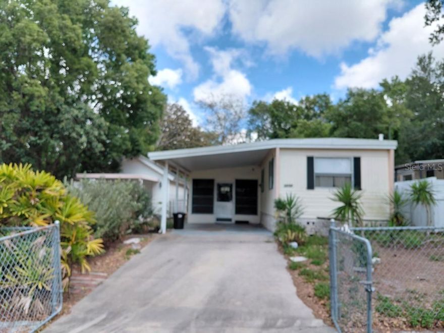 2BD/1BA mobile home (570 sq ft) with two driveways, detached 1-car garage (electric & concrete), and front carport. Newer TPO roof, mini-splits, electrical panel, and water heater. Vinyl plank flooring, open kitchen with butcher block counters, updated bath. Fenced yard, city water/sewer. Built in 1972.