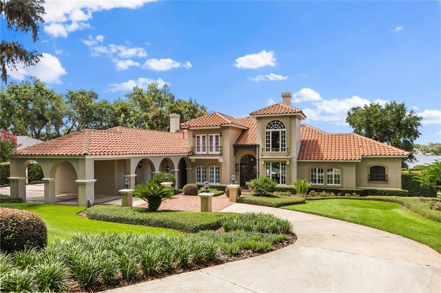 A rare opportunity to own one of the most distinguished lakefront estates on Lake Brantley, Central Florida’s premier private, sand-bottom ski lake.  This custom-built estate spans 4,956 square feet, featuring 4 spacious bedrooms, 5.5 baths, a private library, wine cellar/basement, and an oversized three-car garage with a stately porte-cochere. Gas lanterns invite you beyond custom mahogany entrance doors to soaring 20-foot ceilings and expansive lake vistas.  Two wood-burning masonry fireplaces, and a wealth of architectural details—extensive use of St. Louis brick, hand-scraped hard-wood flooring, and artesian crafted wrought iron throughout. Designed for the distinguished homeowner, the exquisite cherry-paneled library (or office) is a masterpiece of craftsmanship. The open-air pool and spa, fully equipped summer kitchen, and lush lawn unfold onto a private sandy beach where you can even build a sandcastle. A private dock with boat lift invites boating, skiing, or simply taking in the peaceful lake views. As twilight falls, the estate comes alive with a complete landscape lighting package, setting the scene for evening entertaining or tranquil nights under the stars. This luxury home is situated on 1.25 acres with flawless landscaping. This architectural masterpiece embodies refined relaxation right in the heart of Longwood - one of Seminole County’s most established and sought-after communities. Known for its A-rated schools, tree-lined streets, and timeless appeal, Longwood offers the perfect blend of tranquility, prestige, and convenience, with quick access to boutique shopping, upscale dining, major highways, and Orlando’s top employers. This is more than a home—it’s a one-of-a-kind legacy property that offers elegance, privacy, and Lake Brantley living at its finest.