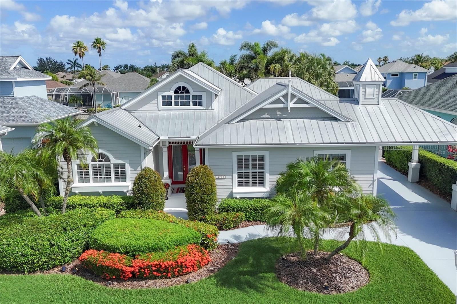 Key West-inspired waterfront home in premier boating community of The Inlets! Beautifully updated 3-bedroom, 2.5 bath offers a refined coastal style designed for seamless indoor-outdoor living. Surrounded by lush tropical landscaping, the home is thoughtfully laid out with an open floor plan, high ceilings, crown molding, and disappearing-corner sliding glass doors that effortlessly connect the interior living space to expansive screened patios. The kitchen is both functional and stylish, featuring white cabinetry including a floor-to-ceiling pantry cabinet, granite countertops, tile backsplash, and a suite of stainless steel appliances including a gas range and double electric oven. A spacious laundry and pantry room offers abundant storage with floor-to-ceiling shelving. The primary suite is a private retreat, complete with pool views, lanai access, dual closets (one walk-in), and a generous en suite bath with two vanities, a garden tub, walk-in shower, and private toilet. A split-bedroom layout ensures privacy with two additional bedrooms, a full hall bath, and a separate half bath easily accessible from the outdoor living area. Step outside to an expansive covered lanai and paver patio, where a heated saltwater pool and spa invite year-round enjoyment. A remote-controlled awning and solar shades provide comfort and privacy for dining waterside or lounging in the shade. The 3-car tandem garage includes rear double doors opening to the canal, offering convenient access for boat maintenance and storage. Notable updates include 2024 paint on exterior, garage and driveway; 2020 HVAC, 2022 pool pump, 2023 gas heater and remote control automation with salt cell. Bring your boat and enjoy the best of waterfront lifestyle, dock up to a 36 ft boat with power and water to enjoy boating, fishing, and visiting local waterfront restaurants & venues by boat. Access to Manatee River & Gulf, many social activities, tennis, walking trails, fishing dock, kayak launch, playground, sidewalks, and gas-lit streets. Located minutes from I-75 and SR-64, with easy access to Sarasota, St. Pete, Tampa, airports, dining, shopping, and Gulf Coast beaches. No CDD, Low HOA fees, and low flood insurance add to the appeal of this exceptional waterfront home.