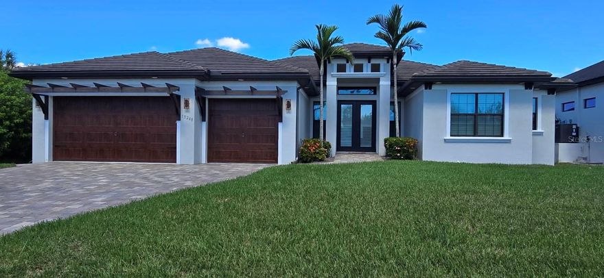 CUSTOM GULF ACCESS WATERFRONT POOL HOME!
Don’t miss this stunning custom-built residence featuring 3 bedrooms, 3 bathrooms, and a den. Designed with high-end finishes throughout, this home perfectly blends luxury living with the best of Florida’s waterfront lifestyle.

The open-concept floor plan highlights tray ceilings, 8-foot doors, and a spacious great room ideal for entertaining. The gourmet kitchen boasts Cambria quartz countertops, a waterfall island, custom cabinetry, and a large walk-in pantry.

Additional upgrades include impact-rated windows and doors, plantation shutters, built-in speakers, a whole-house reverse osmosis system with a 500-gallon tank, and a smart irrigation system.

The primary suite is a true retreat with two sets of sliding doors featuring drop-down electric screens, peaceful waterfront views, dual walk-in closets, and a luxurious spa bath with a walk-through shower and rain shower fixture, soaking tub, and dual vanities.

Step outside to your private tropical oasis, designed for relaxation and entertaining. Enjoy a summer kitchen, custom-built Churrasqueira brick grill, and a heated saltwater pool and spa overlooking the water.

For boating enthusiasts, this property includes a dock with a 10,000-lb boat lift and direct Gulf access via the Myakka River — with only one bridge offering a 24-ft clearance.

This home was thoughtfully designed for comfort, convenience, and waterfront enjoyment.
Schedule your private showing today!