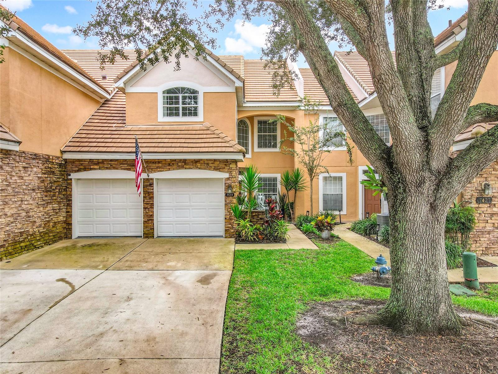Rare opportunity in Phillips Bay! This 3 bedroom, 2.5 bath condo in Phillips Bay right in the heart of Dr. Phillips is clean, inviting, updated, and ready for its new owner! The first floor has a formal entry with formal living room, pass through kitchen and open to the dining and 2 story ceiling family room, complete with wrap around real fire place! The rear patio is enclosed with AC to make it comfortable and usable year round. The bedrooms are on the second floor, with the primary quiet roomy and the primary bath containing all the features, shower, garden tub, dual vanities, and large walk in closet. Luxury vinyl floors throughout, laundry room inside, attached 2 car garage, no rear neighbors! Phillips Bay is a gated condominium community off of Wallace Rd and near Dr. Phillips Blvd, just north of Sand Lake by Bay Hill, Universal, I-Drive, Dr. Phillips High School, and all the amenities Dr. Phillips has to offer. Come see this one quickly!
