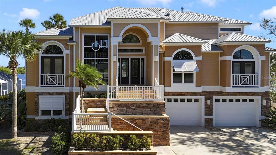 Welcome to this exquisite Intracoastal Waterway estate, a true tropical paradise offering luxury, privacy, and breathtaking views in the heart of Flagler Beach. Surrounded by lush, manicured landscaping, this six-bedroom, four full and two half-bath home showcases stunning architectural details and elegant craftsmanship throughout. As you enter through the grand double glass doors, you are greeted by panoramic views of the Intracoastal, soaring ceilings, and an abundance of natural light pouring through the massive windows and sliders. The bamboo wood flooring, decorative niches, fireplace, and exquisite crown molding create a warm atmosphere. The main level features a formal dining room, open living area, spacious breakfast nook, and three bedrooms with two and a half baths, perfect for family or guests. The gourmet kitchen is a chef's dream, featuring granite countertops, custom wood cabinetry, a center island, and stainless steel appliances.

The master suite, located on the private third floor, offers a peaceful retreat with its own balcony overlooking the water, fireplace, large walk-in closet with washer and dryer, and a luxurious spa-like bath complete with dual granite vanities, walk-in shower, and jacuzzi tub. The ground floor is designed for entertainment and comfort, boasting a large game room, two additional bedrooms, and an office. A three-car garage provides ample parking and storage space. Step outside and experience Florida living at its finest, with two balconies, a large lanai, and a pavered pool deck surrounding the sparkling pool and in-ground spa. Enjoy boating from your private dock with boat lift and slip accommodating up to a 12,000 lb vessel, 2 jet ski lifts and a spacious deck and seating area. Additional features include a metal roof and hurricane shutters for peace of mind. Nestled on a quiet street, this home offers easy access to the beach, parks, schools, bike paths, golf courses, shopping, and restaurants. This is more than just a home, it's a lifestyle of luxury and waterfront serenity. Call today to schedule your private showing.