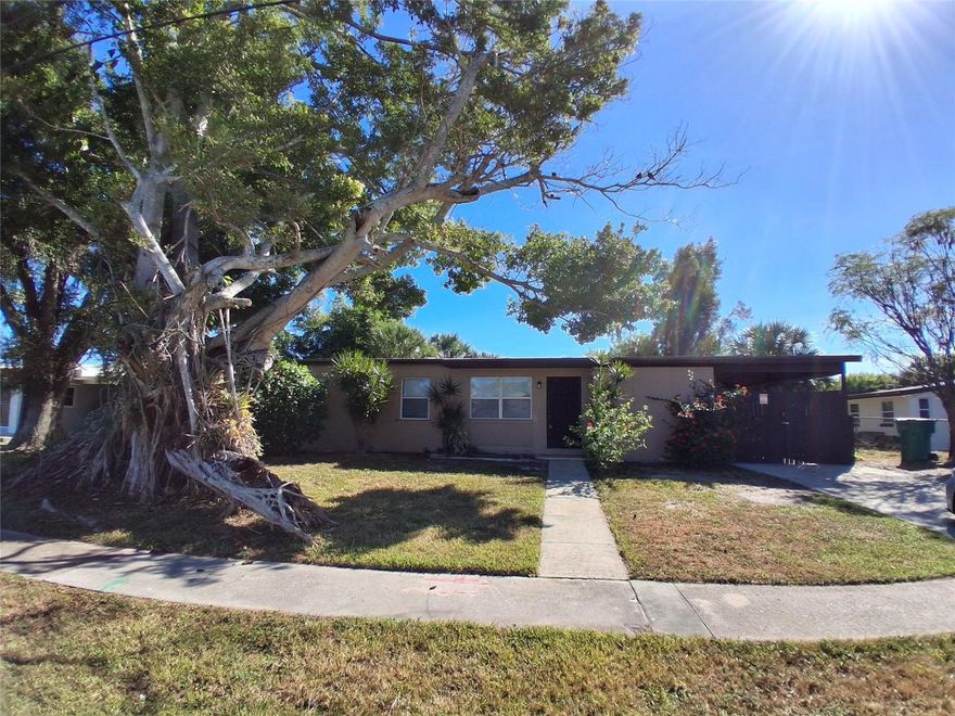 Welcome to this charming 3 bedroom 1 bathroom single-family home offering comfort and convenience. Nestled in a quiet residential neighborhood surrounded by mature trees, this property provides a perfect blend of modern updates and cozy living spaces.

Step inside to find a spacious open-concept living and dining area with gleaming tile flooring throughout, providing both durability and easy maintenance. The galley-style kitchen is thoughtfully designed with granite countertops, custom dark wood cabinetry, and sleek black appliances including a refrigerator, stove, and dishwasher. Tile backsplash accents and recessed lighting add a touch of sophistication, while plenty of counter space makes meal preparation a breeze. A convenient rear door provides quick access to the backyard and carport area, perfect for outdoor dining or weekend barbecues.
Each bedroom offers walk-in closet space, ceiling fans, and large windows that let in an abundance of natural light. The bathroom features modern fixtures, a tiled shower-tub combo, and stylish finishes that make daily routines feel a little more luxurious.
Outside, the home is surrounded by lush greenery, including a striking mature tree that provides shade and enhances curb appeal. The fenced side yard offers both privacy and space for pets, gardening, or simply enjoying Florida’s sunshine. There’s also a private driveway and covered parking area, providing added convenience.
Located just minutes from local shops, restaurants, schools, and parks, this home offers the perfect balance of peaceful residential living and easy access to city amenities.