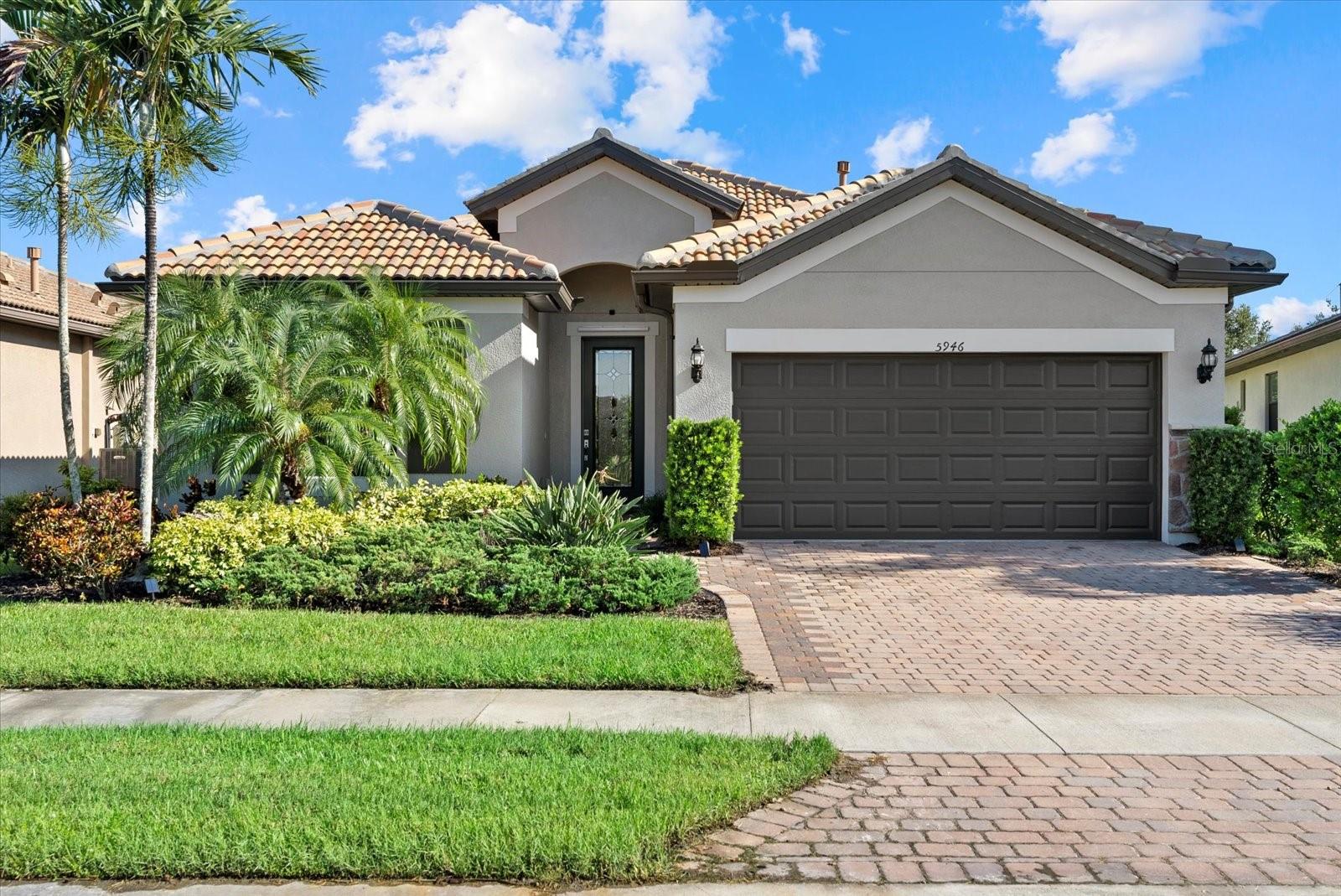 One or more photo(s) has been virtually staged. Welcome to this beautifully appointed Summerwood model featuring 2BR, 2BA with a versatile den and a tandem 2-car garage offering 1,861 square feet of comfortable living space in the highly desirable gated community of Sandhill Preserve on Palmer Ranch. Step inside to discover endless custom upgrades, including new exterior and interior paint, tile throughout, new light fixtures and fans, window treatments, and an extended covered lanai perfect for enjoying Florida’s beautiful weather. The open floor plan features high ceilings and a natural gas setup, creating a spacious and inviting atmosphere. Premium touches include a front entrance with full light Blackstone decor glass, walnut grain tile, premium maple cabinetry and beautiful French doors with glass on the den. The large custom laundry room adds an extra level of convenience. The chef’s kitchen is a standout, featuring a stunning large quartz island with storage, stylish backsplash, a built-in Marvel 24-bottle wine cooler, and full-extension pull-out shelves in all lower cabinets—perfect for easy organization. Relax in the primary suite with an enlarged walk-in shower enhanced with upgraded tile and a walk-in built-in closet for ample storage. Enjoy elegant Hunter Douglas treatments on all windows and sliders for both style and privacy. Other upgrades include an insulated garage door, convenient pull-down stairway for easy attic access, and an extended driveway with pavers for ample parking. Lush tropical landscaping provides peaceful privacy to the rear, making this home your perfect oasis. Enjoy access to top-rated A+ schools and world-class resort-style amenities, including a resort style pool, heated spa, 24/7 State of the Art fitness center, clubhouse, outdoor barefoot bar, BBQ grills, 2 tennis courts, fire pit, walking paths and a fishing pier to explore all this community has to offer. Located only 8.4 miles away from the world famous white sandy beaches of Siesta Key. Experience exceptional living in Sandhill Preserve, schedule your private tour today!