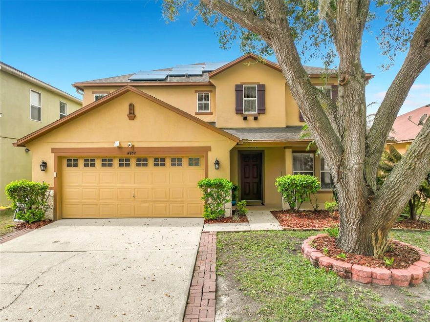 Welcome to 14932 Perdido Drive in the sought-after Waterford Trails community of East Orlando. This well-maintained 4-bedroom, 3-bathroom, 2-story home offers 2,713 square feet of open, light-filled living space - and a backyard pond view that genuinely stops people in their tracks.

The main level flows seamlessly from the formal living and dining areas into an expansive open-concept family room and kitchen -- all on large-format tile throughout. The kitchen features stainless steel appliances, abundant cabinetry, a center island, and recessed lighting, all opening directly to the family room and backyard. Sliding glass doors lead out to a covered, shaded patio overlooking the pond - framed by a stunning mature live oak that makes the backyard feel like its own private sanctuary.

Upstairs, the primary suite includes a spacious en-suite bath with dual vanities, a soaking tub, separate walk-in shower, and tile flooring. Three additional bedrooms and two more full baths give everyone room to breathe.

The big mechanicals are done: new roof (2018), new AC (2019), a fully paid photovoltaic solar panel array (2017), and a solar water heater -- your electric bills will reflect it from day one.

Located in Waterford Trails with access to Castle Creek Elementary, Timber Springs Middle, and East River High School, and convenient to SR-408, 528, and the best of East Orlando.