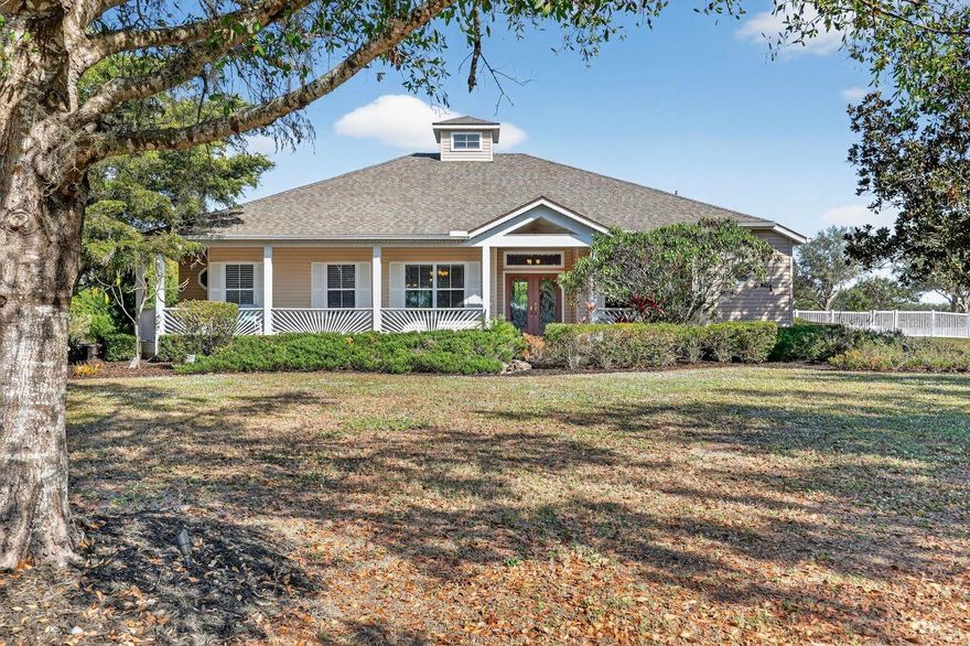 Enjoy tranquil picturesque sunsets from the privacy of your expansive wraparound front porch on over one acre of land!  This must-see home features three bedrooms plus a den and two bathrooms with an open, light-filled floorplan. A large skylight enhances the abundant natural light, while soaring ceilings and a thoughtful layout add to the spacious atmosphere.
The eat-in kitchen includes granite countertops, countertop seating, and an adjacent dinette for casual meals, and it seamlessly connects to the large living room—ideal for entertaining. A separate formal dining room is perfect for special occasions.
The den, complete with a transom window and French doors, can easily be converted into a fourth bedroom. The primary suite boasts a tray ceiling and two walk-in closets. The primary bathroom features dual vanities, a jetted tub, and a spacious double shower. The guest bathroom offers two vanity sinks and a step-in tub. Additional conveniences include fully screened and covered patio, and an inside laundry room. Recent updates comprise a newer roof (2020), luxury plank wood flooring (2020), interior paint (2025), and new outdoor landscape lighting. Exterior highlights include low-maintenance (no painting needed) vinyl siding, a two-car attached garage, and a fully fenced yard for your furry friends.  If you are looking for a home surrounded with large open spaces instead of a cookie-cutter home on a postage stamp lot, this should be on top of your list!