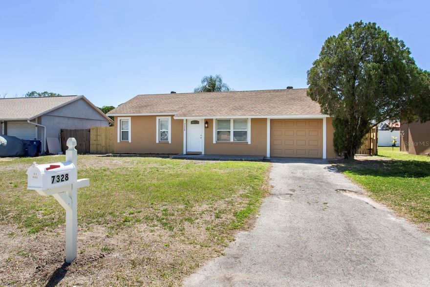 This charming home is ready for you to move in! Come check out this cozy 2 bed, 1 bath, 1 car garage home with a fenced in back yard.  Perfect for the first time homeowner or if you are looking to downsize. Brand new roof (2026), freshly painted, new interior doors, light fixtures, updated bathroom and new appliances.  Home features vaulted ceilings, tile throughout, mirrors on your closet doors, and blinds on windows. Come see for yourself how cute this one is! All this is found in the quiet community of Seven Springs Homes. Zoned within the sought-after school zones of Seven Springs Elementary, Seven Springs Middle, and James W. Mitchell High. Great location close to shopping, restaurants, gyms, and a short drive to Tampa International Airport and Florida Beaches! With NO HOA restrictions, this home is a true gem in New Port Richey.