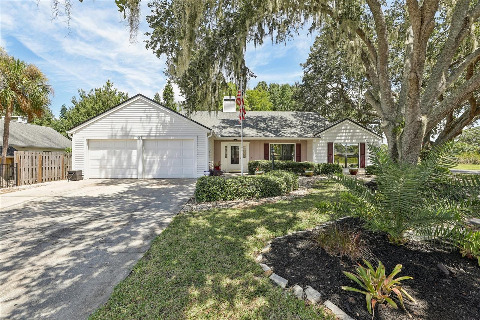 This stunning 4-bedroom, 2-bathroom pool home, a Parade of Homes Remodel award winner, is a true gem. Situated on an oversized corner lot, it boasts an abundance of mature trees and lush landscaping, creating a serene and private oasis. Step inside to a bright, open, and versatile floor plan that is easily adaptable to any lifestyle. The home features fresh paint throughout and no carpet, with newer luxury vinyl flooring, ceramic tile, and hardwoods for a clean, modern look. The great room is a showstopper, anchored by a beautiful stacked stone fireplace with a wood mantle. This space flows seamlessly into the sunny dining area and kitchen. The kitchen is a chef's delight, complete with custom warm wood cabinetry, granite countertops, a pantry, a built-in desk, and a prep island. It features top-of-the-line stainless steel appliances, including a gas and electric cooktop, a Bosch dishwasher, and a built-in oven with a warming drawer. The primary suite is a private retreat with a one-of-a-kind ensuite bathroom. It includes an oversized jetted tub with color changing lights, skylight and a unique stacked stone waterfall feature and step down shower for a serene retreat. A second bedroom with an oversized walk-in closet has vaulted cedar ceilings and offers flexibility as a bonus room and has direct access to the pool area. Two additional spacious bedrooms share a well-appointed bathroom. The home also features custom blinds, ceiling fans, and an inside laundry room. The outdoor space is an entertainer's dream. The sparkling, heated, screened-in pool has a waterfall and lighting features, along with multiple entertaining spaces. These areas are enhanced with built-in surround sound speakers, ceiling fans, and a separate paver patio with vaulted cedar ceilings and highlighted by a stacked stone wood-burning fireplace. Additional features include energy-efficient double-pane windows, a Generac generator, a reverse osmosis water filtration system in the kitchen, a buried propane tank, a roof less than 5 years old, and custom gutter guards. A storage shed provides extra space for all your outdoor needs and a side entry driveway provides access to the backyard. Located in a well-established neighborhood with no HOA, this home offers easy access to downtown and the waterfront Tavares areas. Tour it today and discover your new dream home!