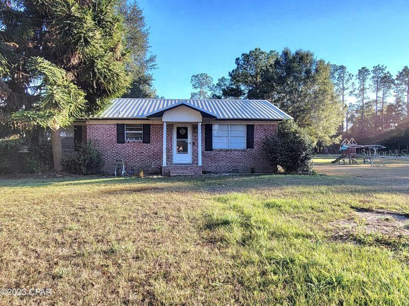 *CURRENTLY UNDER CONTRACT, SELLER WILL CONSIDER BACKUP OFFERS** This beautiful 2 bedroom, 1.5 bath brick home is located on the outskirts of Malone. It sits on a spacious 5-acre lot setback from the road with a beautiful canopy drive providing plenty of space to roam and enjoy the beauty of nature. This property boasts an array of fruit trees such as satsumas, lemons, olives, blueberries, blackberries, figs, scuppernong and many others. It also offers a large barn with 3 stalls perfect for horses. There is also housing for chickens, quail, rabbits and a separate fenced pasture for goats. (Some fencing needs repair) This house is warm and inviting with a cozy wood burning fireplace. The kitchen comes equipped with gas or electric hookup for your stove and beautiful tile flooring. Its secluded charm offers you peace and tranquility. It's a perfect retreat for nature and animal lovers alike. This house has everything you are looking for. Call today to see if this is a place you could call home!
