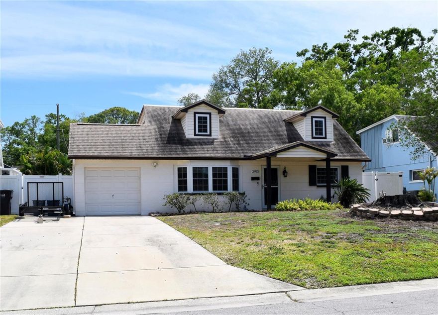 This is the beautiful St Pete home you have been searching for! The gorgeous 11'x19' pool with huge 8'x8' custom spillover heated spa with multiple jets and fountain built in 2023 is ready for a summer of fun, there is plenty of room on the large paver patio for gatherings throughout the year. 
This tastefully updated home features a spacious, elegant kitchen, beautiful luxury vinyl plank flooring throughout the living areas and all bedrooms, a fully renovated upstairs bath, 2022 Air Conditioner, wood burning fireplace in the 25'x19.5' great room, 2020 roof, 2020 Electrical upgrades, impact windows/doors and so much more! This desirable home is 1,958 SF with 4 Bedrooms, 2 Baths, 1 Car 300 SF deep garage with washer and dryer location for a possible option to create an air-conditioned laundry room.
From the covered front porch, entering this desirable home you are greeted through the attractive front door (with glass storm door) into the 15.5'x14' formal living room where the sizeable windows with custom fabric shades bring in the sunshine by day, the attractive chandelier lights up the room at night. Step into the chef's dream kitchen with a gas cooktop, double wall ovens, granite countertops and bar, built-in wine rack, recessed lighting, bountiful cabinets with large drawers and 2 corner base cabinets with turning shelves. 
When cooking you can still engage with family in the great room while they enjoy the wide breakfast bar, fireplace and spacious layout, ready to suit your living style. Use the remote to work the custom window shades.  Downstairs there are 2 bedrooms and a full bath with tub/shower combo, under stair storage, a linen closet. Bedroom #1 is 11'x13', BR #2 is 9'x10'4". Upstairs you will find 2 very large bedrooms as well as the 5'x12' renovated, elegant bathroom and a linen closet. Bedroom #3 is approximately 11'x18', bedroom #4 is approximately 12'x18'. Both bedrooms have attractive lights, a closet plus dormer storage closets.
The long double driveway can accommodate 4 cars, white vinyl fenced back yard with an attractive storage shed, gated parking area on the side of the house for a golf cart or other toys.
Unincorporated Pinellas County has less restrictions which can allow boat/trailer parking.
X flood zone with the house several feet higher than the road.
Walk a few blocks within Fairview Estates to experience the tranquility of Sawgrass Lake Park featuring an educational center, pavilion, walking paths along the water, scenic boardwalks over the wetlands to the dock with a tower overlooking vast Sawgrass Lake where you can view gators, turtles, birds and other Florida wildlife. Convenient to downtown St. Pete, I-275 to Tampa Airport, St Pete or other Pinellas County beaches, shopping and restaurants are minutes away. 
Hurry, make an appointment to view this incredible home!