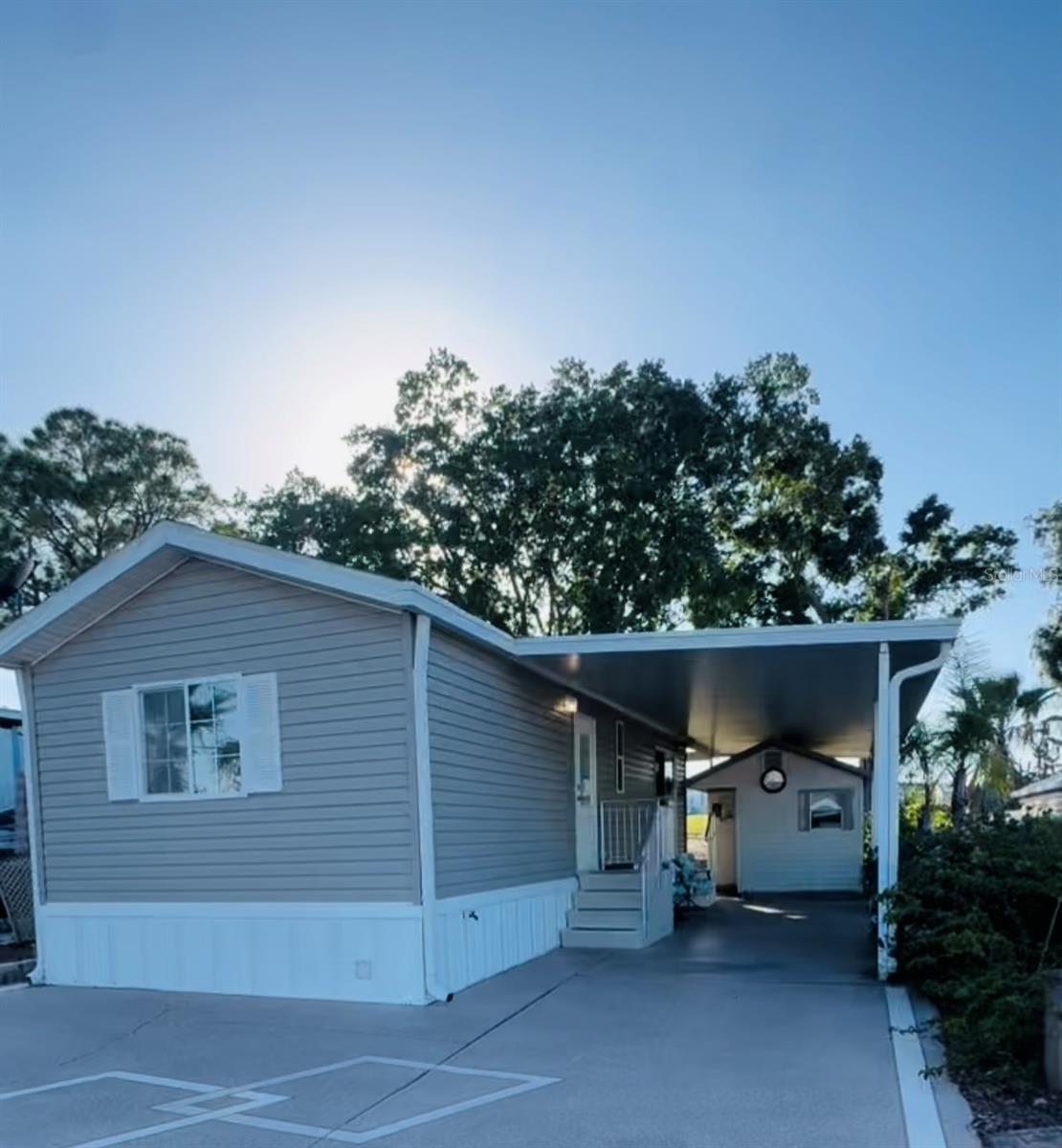 WELCOME TO DEER CREEK RV GOLF & COUNTRY CLUB! Enjoy 55+ RESORT STYLE LIVING in this 1 bedroom, 1 bath home located on the golf course in The Regal Ridge Co-Op Community! Live full time or make this your NEW FLORIDA RETREAT! Enjoy watching the golfers on the 1st fairway of the golf course or the sandhill cranes from your covered backyard! The front patio is perfect for entertaining family & friends or just relaxing & reading a book. This well-maintained home boasts nice kitchen cabinets, new roof, gutter guards & newer windows. Some furniture & furnishings are included in the sale! The 10 x 12 shed is finished with a portable ac unit & is perfect for an office or extra space for guests. Looking for a low HOA FEE? Regal Ridge is the place to be! This property also includes one certificate reducing your HOA to $115 a month & discounts on golf. Meet your friends at The Regal Ridge Community Pool & picnic area close by! Deer Creek also has the MAIN CLUBHOUSE offering a variety of social events throughout the year such as Karaoke Night, Cardio Drumming, Line Dancing, Crafts, Swing Dancing & more! Soak up the sun at Deer Creek’s MAIN pool, cabana & hot tub area! Try water volleyball, pickleball, tennis, shuffleboard or pool aerobics! Love golfing? Check out Deer Creek’s 18 Hole Executive Golf Course, leagues, & shopping at Pro Shop! The Tiki Bar is a great place to meet new friends with occasional live bands & music! The Greenside Grill is perfect for onsite dining! Deer Creek is centrally located in Davenport just 20 minutes from Disney & all the attractions that families enjoy! Hop on your golf cart & ride to many restaurants & shops nearby. Bealls, Marshalls, Target & Star Bucks are in Posner Park less than a mile away! Call today to view this HIDDEN GEM in sunny Florida! Just 1.5 hours to each COAST! Looking for a slice of paradise? Come & take a tour of Deer Creek Community today!