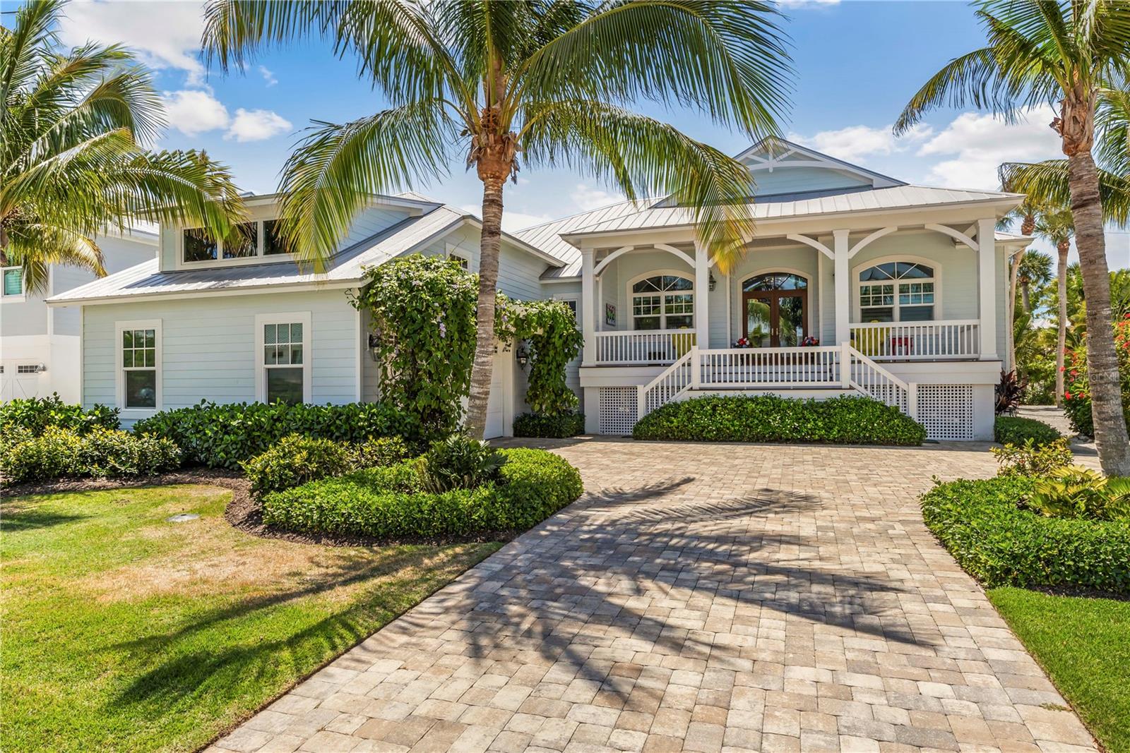 This charming Key West-style home, built in 2016, offers the perfect retreat just south of town. Featuring 3455sf with four bedrooms, five baths, volume ceilings, and an open floor plan. Premium custom cabinetry and trim, quartz countertops, and beautiful wood floors throughout the bedrooms and living spaces add to the home's appeal. Recent additions include a pool-view workout room and a bright top-floor family room with a wet bar and a full bath. The property features a welcoming front porch with views of the renowned Range Light and a back patio overlooking the sparkling pool and deck. Durable construction materials like concrete composite siding, Galvalume metal roofing, Azek trim, and impact-resistant windows and doors ensure long-lasting quality. Situated in a prime island location, this home is just steps from a secluded beach path and within walking or golf cart distance to the historic village of Boca Grande. Rooms are virtually staged.