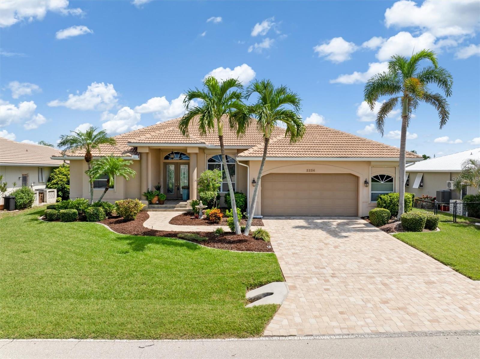 STUNNING SAILBOAT WATERFRONT POOL HOME IN PUNTA GORDA ISLES! Experience the ultimate in Florida living with this meticulously maintained custom waterfront home featuring over 2,300 sq. ft. of living space. Designed for both comfort and entertaining, this home offers separate living and dining rooms, a spacious family room, and a beautifully appointed kitchen with a breakfast nook. Step outside to your private paradise—a heated pool and spa overlooking 80 feet of sailboat waterfront. The extended lanai with a panoramic screen enclosure maximizes breathtaking water views and provides the perfect space to relax or entertain. Enjoy quick access to Charlotte Harbor in just 10 minutes! Inside, you’ll find soaring volume tray ceilings, with crown molding and accent lighting, decorator light and fan fixtures, and abundant natural light. The chef’s kitchen features granite counters, wood cabinetry, two pantries, a wall oven and microwave, gas cooktop, and a three-door refrigerator—all opening to the family room with a custom-built entertainment center and bookcases.
The luxurious primary suite offers two walk-in closets and an elegant ensuite bath with a walk-in shower, garden tub, dual sinks, and a makeup vanity. Additional highlights include a laundry room with cabinets and a utility sink, manabloc plumbing and storm shutters on every window and door, including remote-controlled lanai shutters for shade and protection. With boating, fishing, and breathtaking sunsets right from your backyard, this home embodies the ultimate coastal Florida lifestyle. Don’t miss your chance to claim your piece of paradise in Punta Gorda Isles—where every day feels like a vacation!