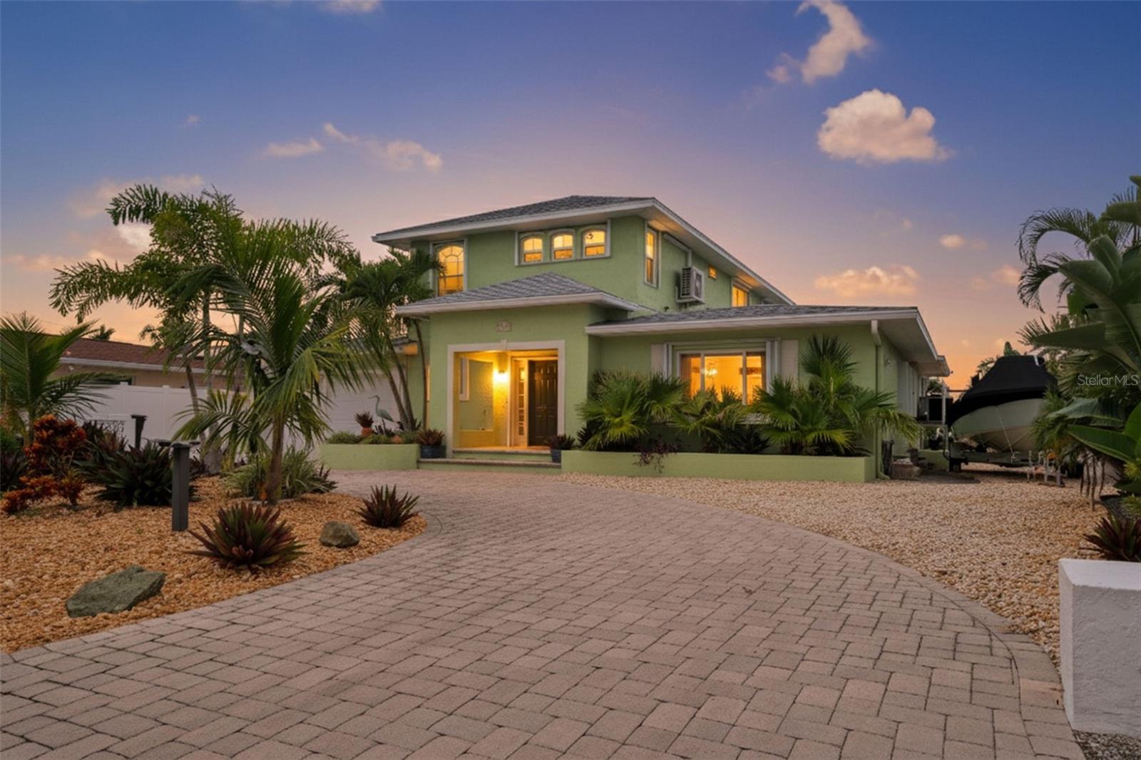 Waterfront home on sailboat water with no bridges to the Gulf of Mexico, located in desirable St. Pete Beach. This well-maintained residence features a 2023 elevated dock and 10,000 lb remote-controlled boat lift with electric and water, offering direct access to open water within minutes. The interior offers an open-concept layout filled with natural light. The updated kitchen with new appliances connects to spacious dining and living areas. The first floor includes a primary en suite bedroom and a second bedroom. The second-floor addition (2000) provides an additional en suite bedroom, office, and bonus room with water views and access to a private balcony. Additional features include newer windows, and hurricane shutters for all openings. Outdoor amenities include a circular paved driveway, xeriscaped yard, enclosed lanai, backyard fire pit, wine garden, and a side yard suitable for boat or golf cart storage. The property is located at the entrance of a cul-de-sac for added privacy. No HOA. Enjoy the ultimate Florida lifestyle just minutes from the white, sandy beaches, dining, and shopping. Move-in ready and built for peace of mind—schedule your private showing today!