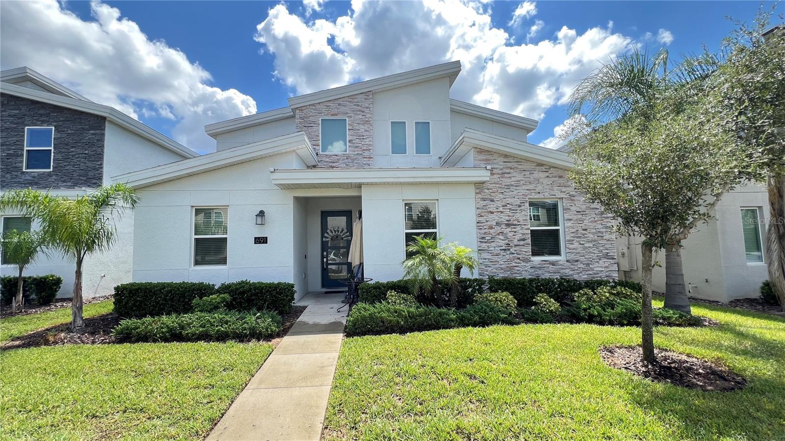 Beautifully furnished 7-bedroom, 5-bathroom single-family home located in the gated Stoneybrook community at Champions Gate. This spacious home features a private heated pool and spa, a modern kitchen with granite countertops and stainless-steel appliances, and a converted garage game room. The first floor includes a master suite with direct pool access, a second bedroom, and a full bath. Upstairs offers five additional bedrooms, including a second master suite, three full baths, a cozy loft-style living area, and a laundry room. The Oasis Club with a 16,000 sq ft clubhouse, restaurant, bar, movie theater, game room, fitness center, yoga room, Camp Oasis, multiple pools, water park, lazy river, tiki bar, sand volleyball, tennis courts, and two 18-hole championship golf courses. Champions Gate is a gated, 24-hour secured community, and the HOA includes cable, internet, lawn care, trash pickup, and full access to resort amenities.