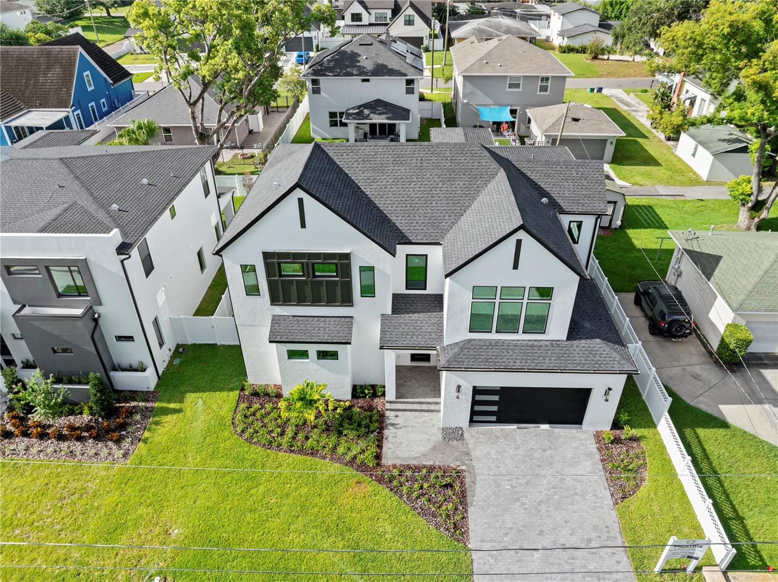 Contemporary Luxury in the Heart of Midtown – 3206 W La Salle Street
Welcome to 3206 W La Salle, a custom-built modern masterpiece tucked within one of South Tampa’s most coveted neighborhoods—just steps from Midtown and minutes from Downtown. Thoughtfully designed with clean lines and elevated finishes, this residence delivers 3,781 sq. ft. of heated living space (4,302 sq. ft. under roof), 5 bedrooms, 4 full baths, 2 half baths, and an oversized 2-car garage.
Step inside to soaring 20-foot ceilings and a dramatic second-story overlook that instantly commands attention. The expansive open-concept layout creates a light-filled atmosphere, perfect for entertaining or relaxing in style. At the heart of the home, the chef’s kitchen stuns with a quartz waterfall island, professional-grade range, and seamless integration to the living and dining spaces. A glass-enclosed wine room with built-in wine fridge adds a touch of refinement, showcasing your collection with elegance.
The first-floor primary suite is a true retreat, offering his-and-hers oversized walk-in closets, a spa-inspired bathroom with dual vanities, an expansive walk-in shower, and the convenience of a private laundry area. Upstairs, a second master suite provides another luxurious haven with a large walk-in closet and en-suite bath—ideal for guests or multi-generational living.
A spacious loft anchors the upper level, overlooking the main floor below, and leads to four additional bedrooms—all generously sized and thoughtfully appointed. An upstairs laundry room adds ease to daily living.
Step outside to your private backyard oasis—fully fenced and complete with a covered patio perfect for al fresco dining, lounging, or future outdoor upgrades.
This home was built with no compromises—impact-rated windows, 8-foot solid-core doors, Level 4 drywall, spray foam insulation, and engineered hardwood flooring throughout. It’s fully pre-wired with Cat 6, indoor/outdoor speaker wiring, and cameras—all centralized through a dedicated data closet for seamless smart home integration.
Unbeatable location: walk to Midtown Tampa, and enjoy quick access to Armature Works, Water Street, Amalie Arena, Downtown, and Raymond James Stadium.
Experience the ultimate blend of luxury, technology, and location—schedule your private showing today.
