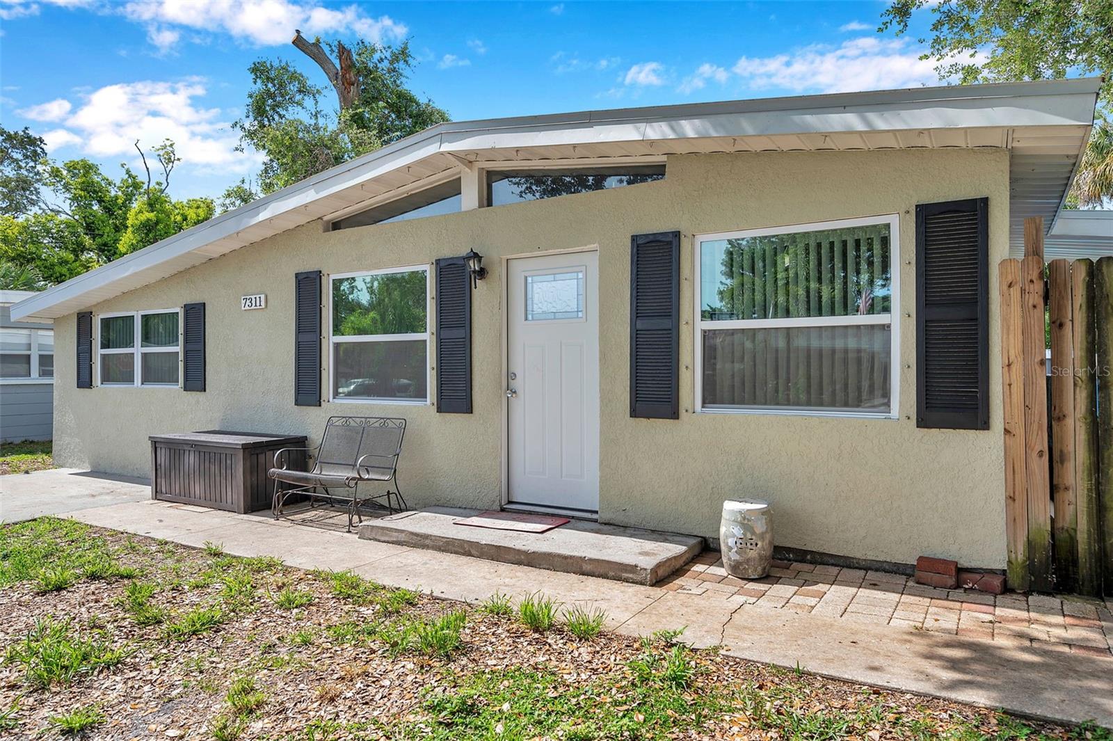 Welcome Home to Pineview Manor, a wonderful home in unincorporated St Petersburg! 3 bedrooms/1 bathroom move-in ready home with all of the updates that you are looking for! New roof installed 2023, New windows and HVAC in 2018, home was tented and a new front door was installed in 2025. Totally updated kitchen with stainless steel appliances and granite countertops as well as updated bathroom! Parking pad offered for off-street parking. As you enter the house, you will notice the vaulted ceilings and gable windows adding to all of the natural light and openness! The light and bright kitchen with white cabinetry and peninsula with seating leads you into the living room and then out onto the screened-in porch. The possibilities are endless with this fenced-in private backyard. Above-ground pool can be used for one more season or removed. Multiple sheds for added storage! The three spacious bedrooms have large closets and share the tastefully updated bathroom. Plenty of closets and storage space throughout the home as well. Conveniently located close to parks, shops, and dining. This is the home you've been looking for - book your showing today!