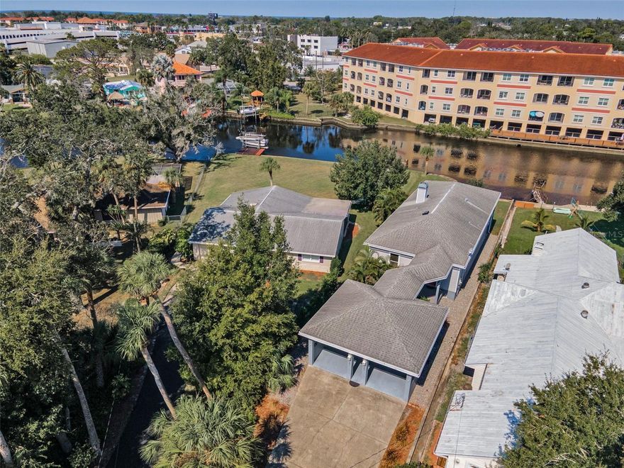 Discover this rare ELEVATED WATERFRONT property with NO HOA on an OVERSIZED LOT in the heart of New Port Richey where you can enjoy GOLF-CART access to downtown shops and dining. Built in 2007, this charming 2-bedroom, 2-bath RIVERFRONT home with a flexible office/bonus room is located just a few blocks from HISTORIC DOWNTOWN New Port Richey and Sims Park. This property combines classic character with modern upgrades, featuring stunning hardwood floors, rich custom wood trim and crown molding, and soaring ceilings. The owners have completed numerous upgrades and enhancements, including hurricane windows and doors, custom wood blinds, custom wood trim throughout, a tankless water heater, and a Generac whole-house generator. The spacious primary suite offers two walk-in closets, a luxurious bath with a garden tub and oversized walk-in shower. The well-appointed kitchen boasts stainless steel appliances, ample storage, and beautiful wood cabinets and wood countertops. The expansive living room features a gas fireplace with an elegant mantle, soaring ceilings, and rich custom wood trim. Relax on the large covered deck overlooking the water, where you can often spot dolphins and manatees passing by or take a boat or jet ski out to the Gulf! This home offers the perfect balance of relaxation and recreation. Ideally located just blocks from Sims Park—a waterfront park with playgrounds, an amphitheater, and community events—this home also provides quick access to downtown shops, restaurants, and hospitals. Conveniently located just 33 miles from Tampa International Airport, this property offers easy access for travel. It’s also only 26 miles from world-famous Clearwater Beach, perfect for enjoying sun and sand. Outdoor enthusiasts will appreciate being just 19 miles from Honeymoon Island State Park, known for its pristine beaches, hiking trails, and birdwatching. New Port Richey has blossomed in recent years, offering a vibrant mix of festivals, concerts, farmers markets, and community gatherings, along with a popular Aquatic Center featuring pools, water slides, and swim programs for all ages. Experience true Florida waterfront living with direct river access and endless opportunities to enjoy life on the water, all while being just moments from the lively downtown New Port Richey scene filled with shops, dining, and entertainment.