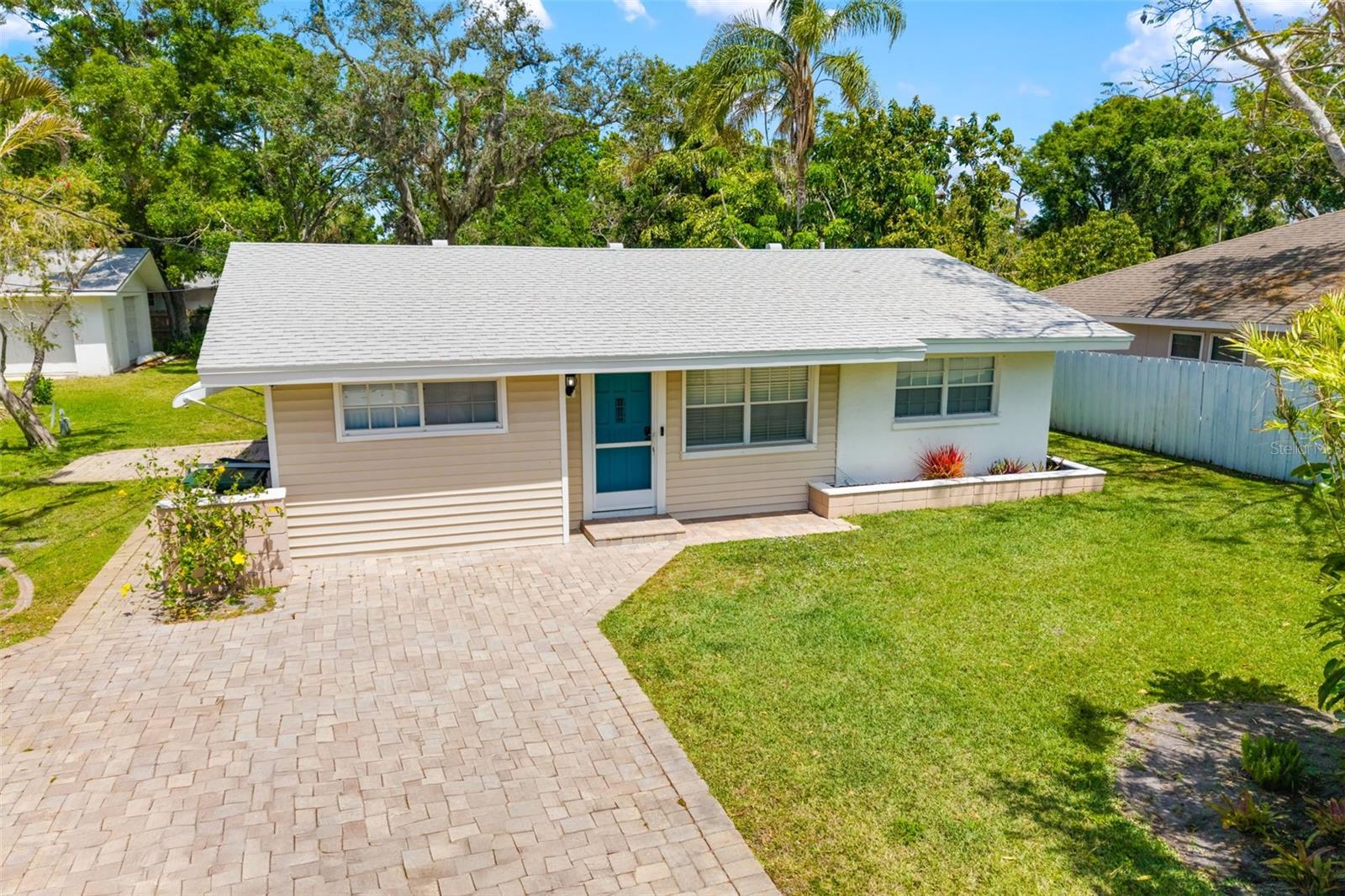 One or more photo(s) has been virtually staged. We are so excited to offer this beautiful four-bedroom, fully remodeled home in the heart of South Sarasota, just minutes to Siesta Key and Turtle Beach. Featuring a lovely mature lot with an inground sprinkler system fed by a private well, on approximately 1/4 acre. With a seamless blend of comfort and style, meticulously designed with indoor elegance and outdoor entertainment. Let’s face it, it’s perfect for family gatherings and guests, showcasing the great raised deck with built-in seating! The property enjoys updated finishes throughout, including modern barn doors, tasteful accent walls, light bright open spaces with gleaming counters. Each room has been carefully crafted to balance contemporary design with practical functionality. Outdoor enthusiasts will appreciate the great multiple entertainment areas surrounding this home. Enjoy morning coffee on the deck, host afternoon gatherings in the fully screened lanai, or relax under the awning-covered side patio with a glass of wine. Where ever you look, the beautiful mature landscaping creates a private sanctuary with extra wide stone driveway. There is plenty of room for a hot tub or pool.
The location is truly exceptional—situated conveniently off US41 across from The Landings with easy access to Phillippi Estates Park, the beaches and shopping.
Recent updates include gorgeous white sparkle quartz countertops, new stainless appliances, new HVAC, luxury vinyl plank flooring throughout, tankless water heater, new lighting, fans, etc. (roof replaced in 2020/2019). This home features a beautiful primary or guest suite, perfect for in-laws, complete with separate entrance, spa-like bathroom with bidet toilet, quartz counter, designer tile, barn doors and living room! On the opposite side of the home you will find 3 additional bedrooms and second bath room. Welcome Home!