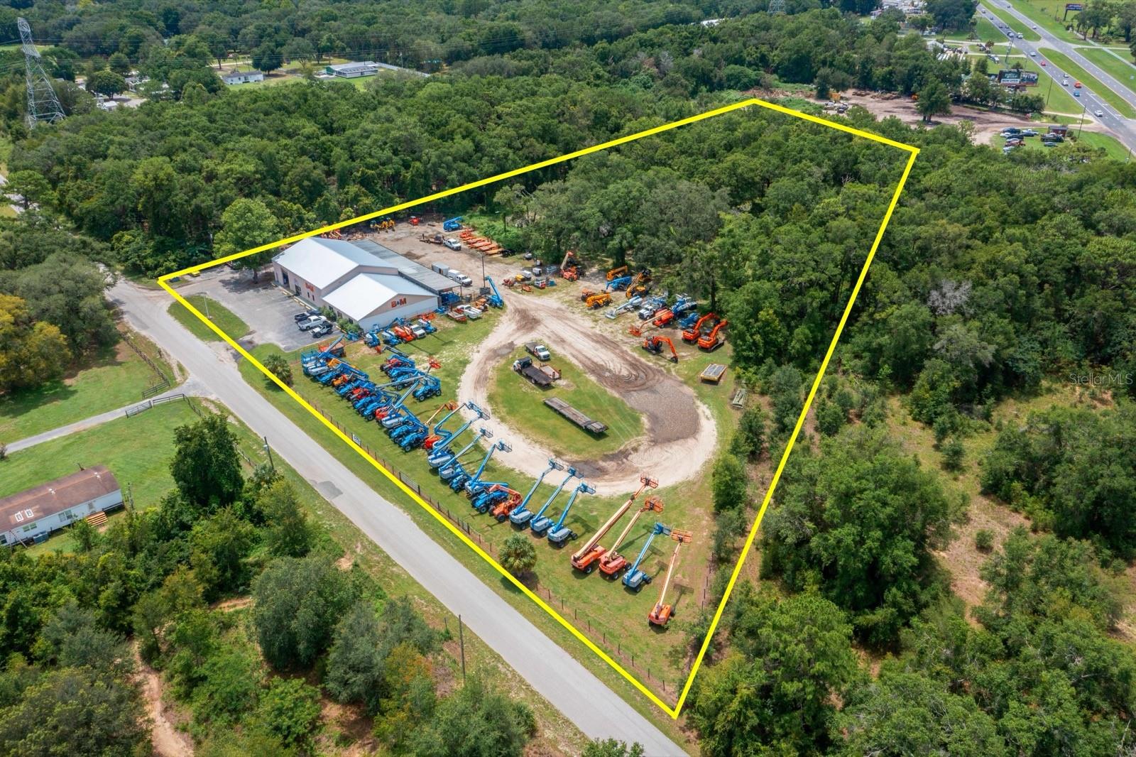 Located just a quarter mile off Highway 441 in Belleview, Florida, this 4.80-acre property offers highly sought after B5 zoning—ideal for a wide range of heavy commercial or industrial uses. Set on a quiet, easily accessible road with direct routes to I-75 via the Belleview exit at CR 484, this versatile site combines functionality, expansion potential, and strategic location in one impressive package.
The property features a 7,560 square foot warehouse with attached office space, making it well-suited for an owner-user or could be a shared two-tenant property. The office layout includes a welcoming reception and showroom area, private offices, a large conference or training room, multiple restrooms, and a break room for staff. A 2,500 square foot covered canopy at the rear of the building adds additional operational flexibility for outdoor work or sheltered storage.
Under new ownership, the property has seen significant upgrades, including a full roof replacement in 2025 and installation of a new 3-ton HVAC system. The owner also plans to clear and grade the remaining portion of the site, creating additional usable laydown yard and outdoor storage space in the coming months. With space becoming available in January 2026, this site presents a prime opportunity for growing businesses or those in need of a well-located operations base. There's also potential for further development, as the owner is considering the addition of a 5,000 square foot warehouse to meet future tenant demand.
This property also benefits from its proximity to The Villages—one of the fastest-growing metro areas in the nation. The Villages consistently ranks among the top in the U.S. for population growth, adding over 35,000 residents since 2020. Likewise, the Ocala Metro has seen explosive expansion, recently ranking as the #2 fastest-growing metro in Florida and #6 in the nation according to U.S. Census data. These trends point to a bright future for commercial investment in this corridor.