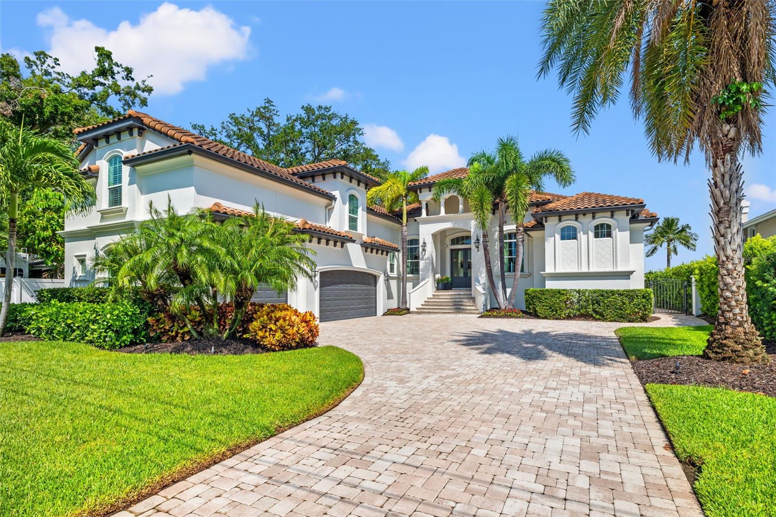 Luxury Waterfront Living on Coffee Pot Bayou – Snell Isle, St. Petersburg
This stunning custom-built 2016 residence captures the very best of Florida’s waterfront lifestyle, perfectly situated on the tranquil waters of Coffee Pot Bayou in the prestigious Snell Isle community. Built with block and stucco construction, on a slab foundation, and topped with a classic barrel tile roof, the home blends timeless craftsmanship with modern luxury.
Inside, soaring 10 feet plus ceilings, hurricane-impact windows and sliding doors, and a whole-home smart system with integrated video, lighting, and sound create an atmosphere of comfort and sophistication. Nearly every space is oriented to showcase serene water views.
The gourmet kitchen is a chef’s dream, featuring a Wolf convection oven and cooktop, a new Sub-Zero refrigerator, Miele dishwasher, water purification system, three full wine refrigerators plus a mini, custom cabinetry, and an oversized center island with seating and a built-in bar—perfect for entertaining.
The main floor primary suite offers privacy and elegance, while a waterfront guest suite with en-suite bath ensures a warm welcome for visitors. Additional spaces include a downstairs office (not counted in the bedroom total) and an upstairs bonus room/bedroom with walk-in closet and full bath.
Outdoor living is equally impressive. A heated, in-ground saltwater pool (installed 2021) is complemented by an exterior half bath, large covered patio with motorized screens, automatic interior blinds, a built-in outdoor gas grill, fireplace, and ample seating areas—all enhanced by the seawall’s newer cap built to current height requirements.
Practical features include a 3-zone heating and cooling system, two insta-hot gas water heaters, a whole-home generator, exceptional storage, and recent updates including fresh exterior paint (2022) and tenting (2025).
Offering direct access to the open waters of Tampa Bay, this exceptional home combines thoughtful design, high-end finishes, and an unbeatable location—ideal for the boating enthusiast and anyone seeking a true Florida waterfront lifestyle.