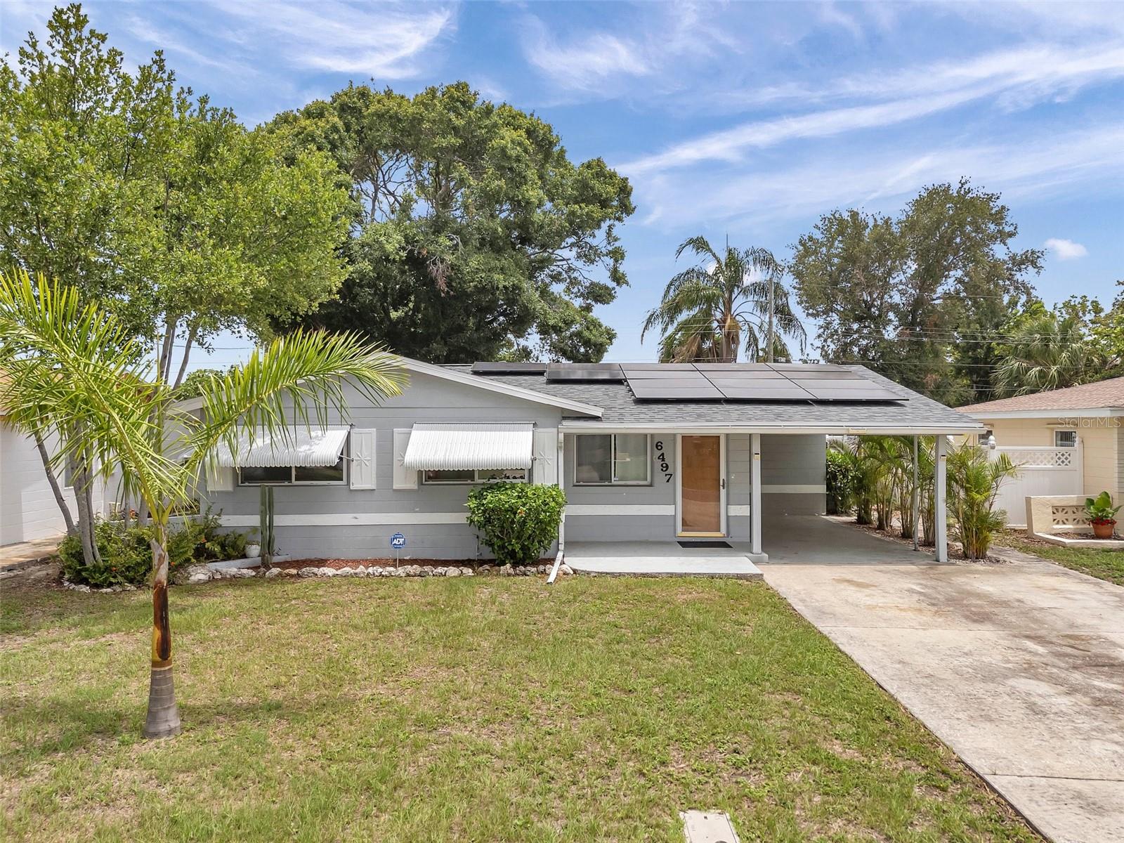 Charming, updated 3-bedroom, 1-bathroom single-family home in a non-flood zone—NEVER FLOODED. Features a brand-new roof (May 2025), new painted Facia boards (May 2025), new hot water heater (Feb 2020), new electric panel (2019) and transferable termite warranty/pest control. Equipped with a 2013 HVAC system and solar panels for energy efficiency. Spacious fenced backyard with an oversized shed, plus a versatile bonus room/sunroom. Includes a 1-car carport and double concrete driveway, ready for your RV or boat. Move-in ready!