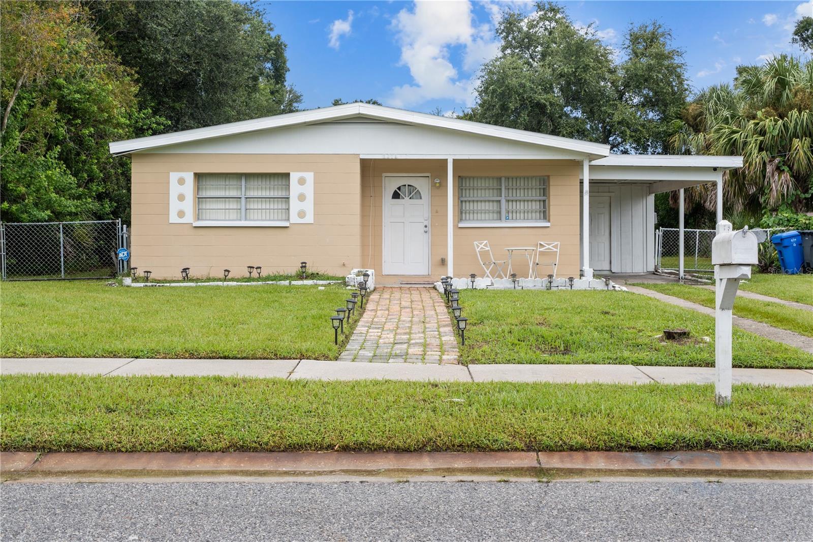 This charming 4 bedroom, 2 bathroom single-family home, originally built in 1960, boasts a spacious layout with two distinct living areas, perfect for entertaining or flexible family living. Enjoy a large backyard, ideal for outdoor gatherings or for creating your dream oasis. This home is being sold "as-is" and features a newer roof and HVAC system, both updated in 2012, providing peace of mind to the new owners. Inside, the bedrooms include comfortable carpeting, while the kitchen and bathrooms showcase durable tile flooring. A convenient carport protects your vehicle from the elements.