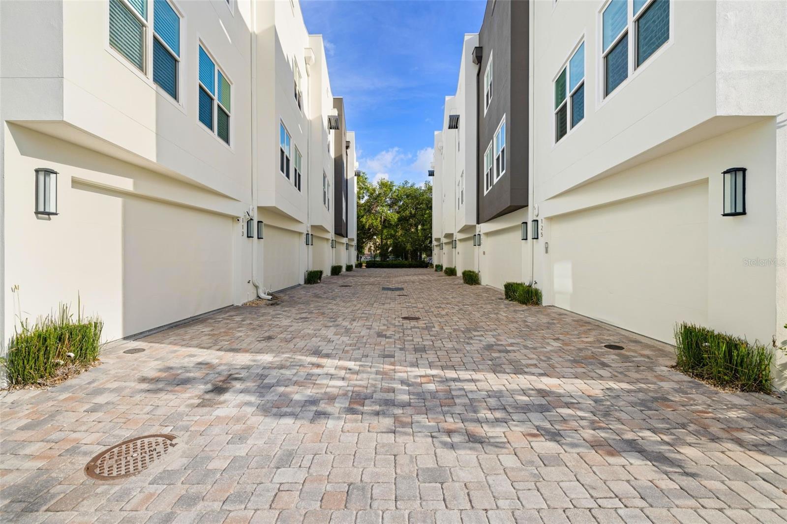 Welcome to this sophisticated, nearly-new residence built in 2019, located in a NON-FLOOD and NON-EVACUATION ZONE, offering 2,376 square feet of beautifully designed living space in one of the most desirable locations—where Downtown St. Petersburg meets Old Northeast. This 3-bedroom, 3.5-bath townhome effortlessly blends modern style with everyday comfort, creating an ideal retreat in the heart of the vibrant downtown scene. Step inside to find a versatile first-floor bedroom with a full bathroom—perfect for guests, a home office, or multi-generational living. Upstairs, natural light pours into the open-concept living area, where soaring 10-foot ceilings and a thoughtfully designed layout create the perfect setting for both entertaining and daily life. The gourmet kitchen is a true showstopper, featuring quartz countertops, a gas range, Bosch stainless steel appliances, soft-close cabinetry, a pantry, and a large center island. Elegant engineered hardwood floors run throughout the main living spaces, adding warmth, sophistication, and continuity. On the upper level, the generously sized primary suite offers a spa-like escape with dual vanities, a large walk-in shower, and ample closet space. Each additional bedroom includes its own en-suite bath, providing both privacy and flexibility for family and guests. A bonus upper-level flex space or media room includes a wet bar and wine refrigerator—ideal for relaxing or entertaining. Enjoy quiet mornings, evening gatherings, or skyline views from your private, pet-friendly rooftop terrace—an inviting space for al fresco dining and sunset cocktails. Built with high-quality materials, the home also features energy-efficient upgrades including a tankless gas water heater and PGT impact-rated windows for enhanced comfort and security. A thoughtfully placed half-bath on the main level, a laundry room, and an attached two-car garage add everyday convenience to this home’s already impressive appeal. Perfectly situated, you’ll enjoy quick access to world-class dining, museums, cultural venues, waterfront parks, and vibrant nightlife. Walk to The Vinoy, the marina, and The Dalí Museum. Tampa International Airport is approximately 25 minutes away, and St. Petersburg–Clearwater International Airport is just 20 minutes from your doorstep. Nearby landmarks include the St. Petersburg Pier and scenic waterfront trails. This prime location boasts a fabulous walking score and access to the best of St. Petersburg living, all with low HOA fees of just $380/month. Luxury, location, and lifestyle converge at 123 5th Ave N—your next chapter begins here.