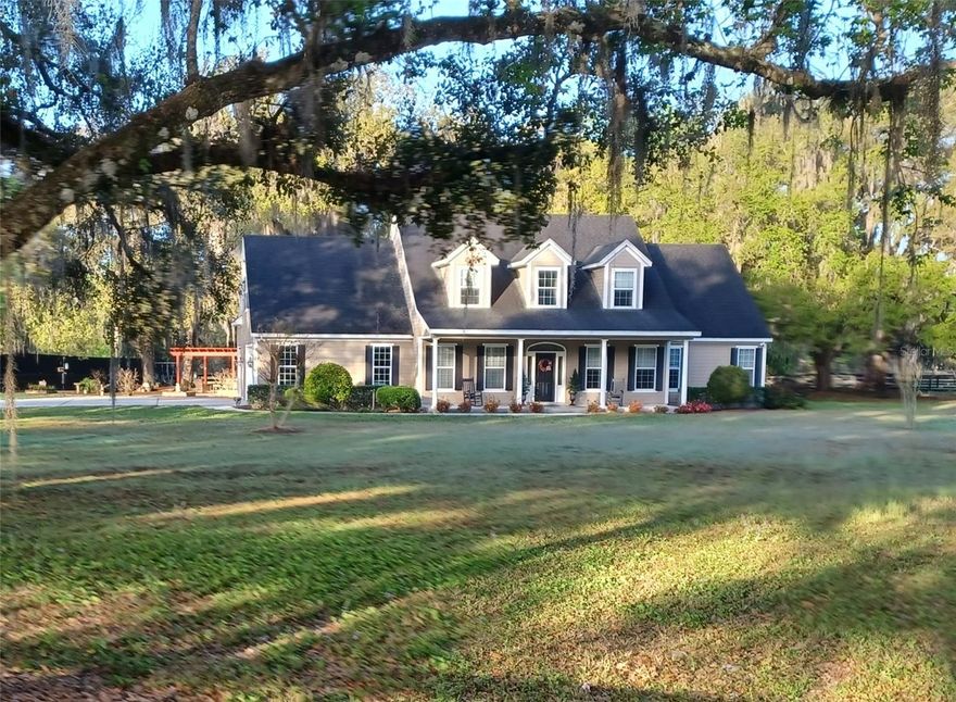 Custom built 3-bedroom 2.5 bath with office, nestled among huge oak trees, on 1.6 acres. Property is totally fenced with 3 board and an electric entry gate in Black Hammock. Home has 3,344 sq. ft. of living area, 839 sq. ft. garage with a car lift and large screened porch overlooking pasture land. Among the many features of this home include, spray foam insulation in roof and walls, coffered ceilings, central vacuum system, custom woodwork throughout, gas fireplace, hard wired security system, designer deluxe, soft close kitchen and utility rm. cabinets, twin A/C units and twin water heaters with water softener. Primary suite, located on the first floor is 16 X 16, large walk-in closet, double vanity, 6 ft. Kohler tub, shower and steam room. Located just minutes from Oviedo and easy access to major routes including S.R. 417.This home has been meticulously maintained and is move-in ready. Properties like this - offering acreage, upgrades and location, rarely come available.