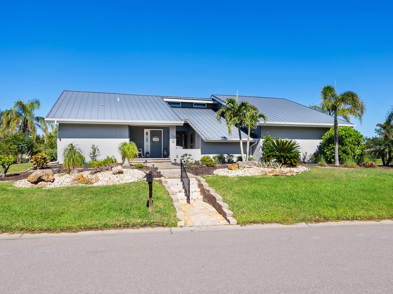 Spacious Custom built home featuring an oversized corner yard, High Ceilings, Updated Kitchen and Bathrooms, Family Room with Wood Burning Fireplace, 3 Bedrooms, 3 Full Baths and a Bonus Room/ 4th Bedroom upstairs. Entertain in the Large Lanai with Outdoor Kitchen overlooking the Pool and wide Greenbelt view. The Stylish and Durable new Metal Roof will protect you for years to come, full Hurricane protection. Attached 2 car garage with workbench and a 3rd garage for your Golf Cart, Boat, Kayak, Bikes etc. All in the Amazing Southbay & Racquet Club where the true Florida Lifestyle thrives! Private Marina, Tennis, Pickle Ball, Community Pool, Waterfront Park, Playground Clubhouse, Fitness Room and So much more!