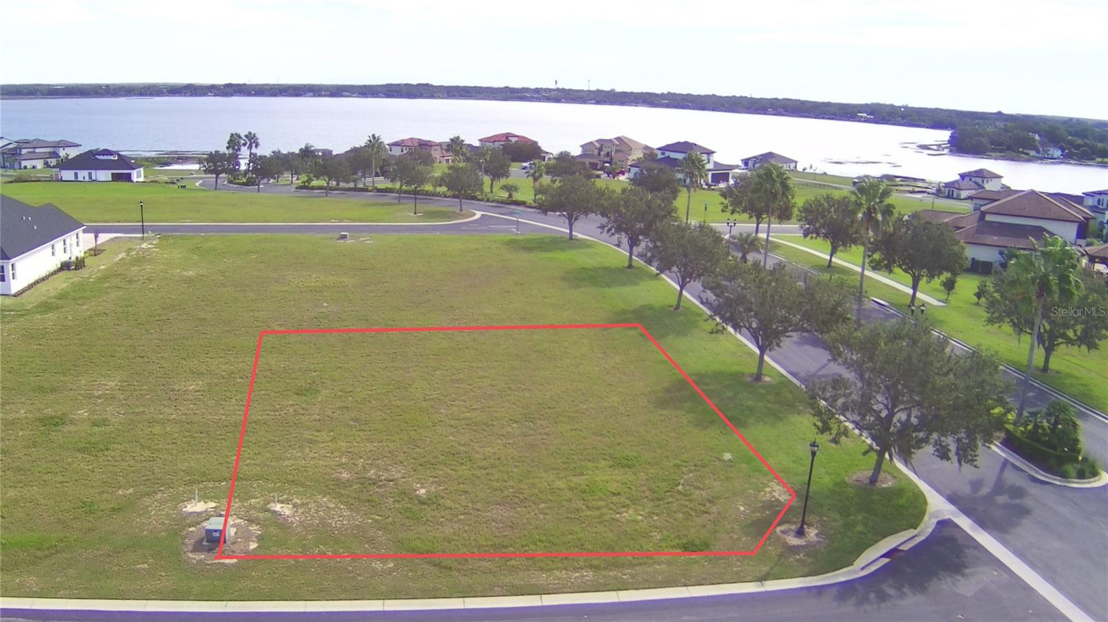 Price Reduced on this gorgeous corner lot! Welcome to your dream homesite in the heart of Florida surrounded by Lake Alfred, Lake Van, and Lake Medora! Perfect location being only minutes from I-4, yet in a tranquil area off the beaten path. This exclusive Corner lot is located in the highly sought after gated community of Water Ridge and offers a world of possibilities. With a gorgeous tree-lined entrance welcoming you home, this pristine piece of vacant land is your canvas to create the perfect sanctuary. This community is almost complete center of Florida, providing convenient access to both the Gulf and Atlantic coasts or Tampa and Orlando. Enjoy the resort-style living with multiple pools, private lake access to Lake Alfred and Lake Van for fishing and boating and Lake Medora for non motorized activities, tennis courts, basketball courts, a well-equipped fitness center with a sauna, and a gorgeous clubhouse. There's also boat storage available for owners (additional fee applies). Whether you're an outdoor enthusiast or a social butterfly, this property offers the best of both worlds. Imagine morning walks by the lake, afternoons perfecting your serve on the tennis courts, and evenings relaxing in the clubhouse or taking in the stunning sunsets. This is your chance to create a customized oasis in a community that's known for its tranquil beauty and upscale living. With the ideal location in the center of the Sunshine State, you're within easy reach of all that Florida has to offer. Seize this opportunity to build the home of your dreams in one of Florida's most desirable gated communities. Don't miss out on this chance to own a piece of paradise and begin crafting the home and the life you've been dreaming of.