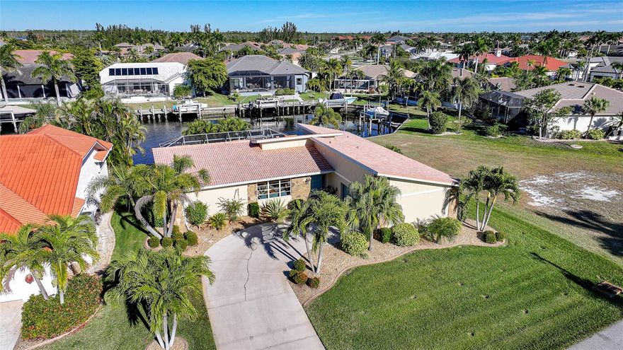 Welcome to your waterfront escape in the highly sought-after Burnt Store Isles community. Tucked away on a quiet street, this beautifully updated 3-bedroom, 2-bathroom, 2-car garage pool home offers the ideal blend of comfort, style, and true Florida boating lifestyle. Perfectly positioned on the St. Florent Canal, enjoy less than 25 minutes to open water, making this home a dream for boating enthusiasts.

Inside, the light-filled layout is designed for effortless living and entertaining. The large kitchen is perfect for gatherings, featuring granite countertops and a clear view of the pool and patio, allowing you to stay connected with guests while hosting. Recent improvements that enhance comfort while enjoying the home’s stunning views include a new HVAC system installed in 2019, providing year-round reliability and efficiency.

The spacious primary suite serves as a private retreat, highlighted by a remodeled walk-in shower completed in 2024 and a fully renovated primary bathroom finished in 2025, offering a refined, spa-inspired experience.

Step outside to your own slice of paradise. The screened pool was completely refinished in 2023 with new coping, while the new pool heater, pump, and pool light installed in 2018 allow for enjoyment in every season. Elegant paver upgrades added in 2019 enhance both curb appeal and outdoor entertaining spaces, all set against peaceful canal views.

Boaters will appreciate the private dock and 10,000-lb boat lift installed in 2018, providing quick and easy access to Charlotte Harbor and the Gulf of Mexico beyond. Whether heading out for a sunset cruise or a day on the water, this home delivers the waterfront lifestyle Punta Gorda Isles is known for.

Ideally located just minutes from historic downtown Punta Gorda, Fishermen’s Village, waterfront dining, shopping, golf, and community events, this exceptional property offers the perfect balance of luxury, location, and relaxed coastal living.