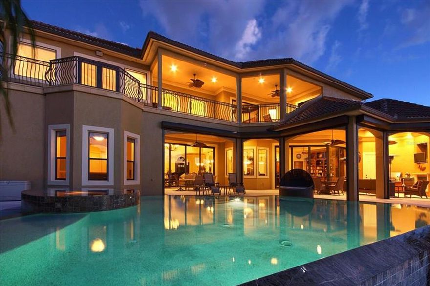 A Rare Waterfront Masterpiece: Ultimate Luxury, Prime Location, Limitless Potential! Welcome to your dream escape in Southwest Florida—where timeless elegance meets unmatched boating access. Whether you're envisioning a private estate, a luxury vacation rental, or a corporate retreat, this impeccably crafted home offers the perfect balance of comfort, sophistication, and opportunity. Nestled on an oversized corner lot, this stunning Koogler-built residence is just one turn from the Caloosahatchee River—no bridges, no locks, and pure open-water convenience. Designed for those who crave the best in waterfront living, this property is both a serene sanctuary and an entertainer’s dream. From the moment you arrive, grand double glass doors with wrought iron detail open to a stately foyer, setting the tone for the home’s refined style. The formal living room dazzles with a dramatic chandelier, stone-accented electric fireplace, and seamless indoor-outdoor flow through expansive sliders to the lanai. Nearby, the formal dining room is an ideal space for elevated entertaining, complete with a wet bar, U-Line appliances, and a Marvel beer tap. The primary suite is a private retreat, showcasing double-door entry, tray ceiling, custom his-and-hers closets, lanai access, and a spa-inspired bath. Indulge in a jetted soaking tub, granite dual vanities, a spacious walk-in shower with dual shower heads, and precision temperature controls. The heart of the home—the chef’s kitchen—is outfitted with premium KitchenAid appliances, a Viking 6-burner gas stove with griddle, dual dishwashers, granite countertops, and a walk-in pantry. A cozy breakfast nook opens to the inviting family room with built-in entertainment and lanai access, creating effortless flow for everyday living or large gatherings. Step outside to a resort-style lanai with a tongue-and-groove ceiling, half bath, built-in GE Monogram grill and refrigerator, and a cozy gas fireplace. The electric-heated saltwater pool and spa feature a sun deck and gated access to your private dock—crafted from composite decking and equipped with water, electricity, and dual boat lifts (10,000 lb and 20,000 lb). 200 feet wide canal, 66 feet dock with 21 feet width. Upstairs, a generous entertainment loft offers a billiards area, full bar with granite counters, and balcony access. Guests will feel pampered in spacious en-suite bedrooms with custom walk-in closets and private balcony access. A well-appointed laundry room with GE Profile appliances and an additional half bath complete the second floor. This versatile luxury residence is as functional as it is exquisite—ideal for homeowners, investors, or business professionals seeking an elite retreat in paradise. Don’t miss this extraordinary opportunity. Schedule your private tour today and experience the pinnacle of waterfront luxury living.