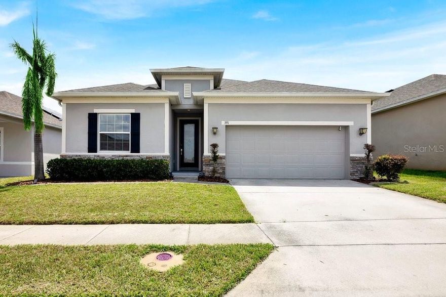 Welcome to this beautifully appointed 4-bedroom, 2-bathroom home nestled in a charming Davenport community, offering nearly 2,200 square feet of thoughtfully designed living space. From the moment you step inside, you’ll appreciate the seamless flow of wood-look tile flooring throughout—no carpet anywhere—providing both style and easy maintenance. This desirable split floor plan delivers both privacy and functionality, while the expansive great room serves as the heart of the home—perfect for entertaining or relaxing. The space opens effortlessly into a true gourmet kitchen, featuring stainless steel GE appliances, a double oven, sleek glass-top range, 42-inch cabinetry with crown molding, a stylish tile backsplash, and a stunning bar-top island that overlooks the living area. The spacious primary suite is a retreat of its own, complete with an oversized walk-in closet, dual vanities, and an impressive super shower designed for comfort and luxury. Throughout the home, elegant touches like crown molding and coffered ceilings add depth, character, and a refined finish. All secondary bedrooms are generously sized, and granite countertops carry consistently throughout the kitchen, bathrooms, and even the laundry area—highlighting the home’s quality and attention to detail. Step outside to your private backyard oasis, fully enclosed with a vinyl privacy fence. Enjoy Florida living year-round with a screened-in patio, an additional open concrete patio for gatherings, and beautifully maintained, low-maintenance landscaping accented by vibrant flower beds. This home combines space, style, and comfort in one exceptional package—ready for its next owner to enjoy.