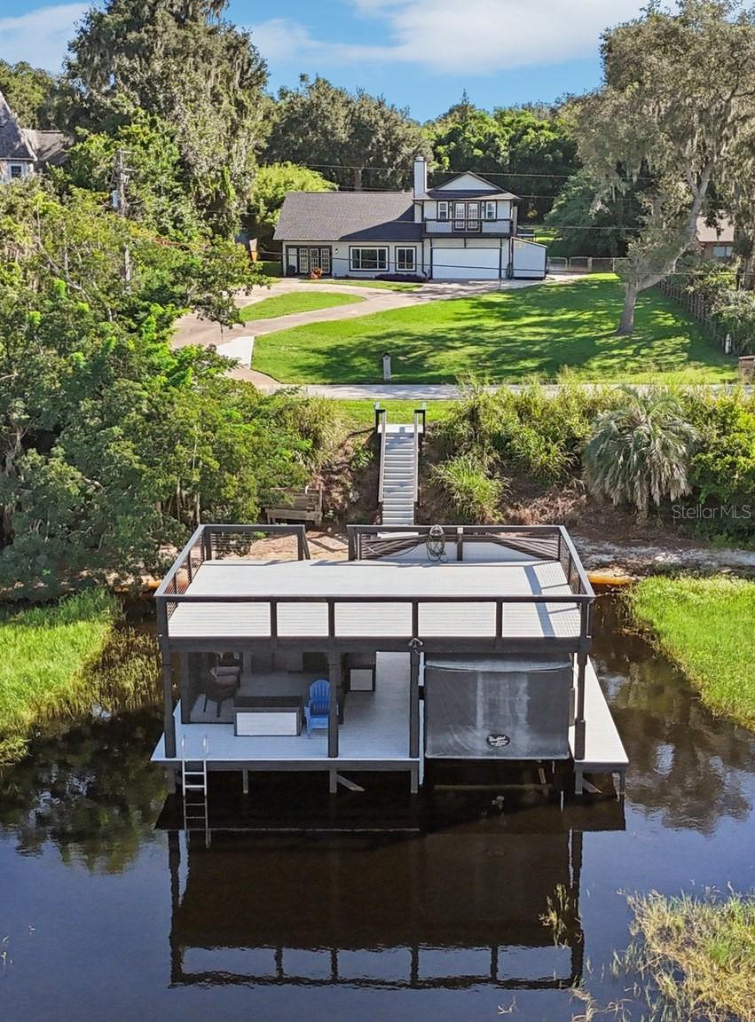 Gorgeous Remodeled Lake Front Pool Home with NO HOA! This 4 Bedroom 2.5 Bath home offers everything you are searching for. Wood
Burning masonry fireplace in Living Room, Split bedrooms, Vaulted ceiling in main entertainment area, Located on Lake Minneola, with access to the Clermont Chain of Lakes, just minutes from the Florida turnpike, Theme parks and more. Updated include NEW ROOF, chimney cap, Interior and exterior paint, Updated Bathrooms with stone counter tops, Pull down faucets and new flooring and more (2025). Tankless Hot water (2022), Pool pump (2024), Gas Pool Heater (2019), HVAC (2019), Windows (2020). Additional features include Hardwood floors on main level, secluded owner's suite on second floor with balcony overlooking the lake. Spacious kitchen features Solid wood cabinets galore, a Walk-In pantry and granite countertops. Family room is open to the kitchen and overlooks the beautiful screened pool area and PRIVATE park-like 1/4 ACRE BACK YARD. Beautiful 2 Story Dock with sundeck, screen room, Covered Fishing/Swimming porch and More! Boat slip features Sea Drive lift with Touchless Boat cover. More features than we can list here - Hurry and check this home out before it's gone!