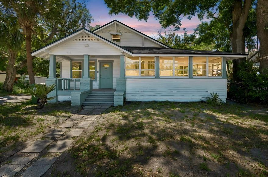 One or more photo(s) has been virtually staged. Beautifully renovated 1925 Craftsman bungalow blending original character with a full top-to-bottom modern refresh. Step inside to find a brand-new kitchen featuring crisp quartz counters, soft sage shaker cabinets, vertical shiplap accent walls, and a deep stainless sink with modern matte-black fixtures. New luxury vinyl plank flooring flows throughout, paired with fresh interior paint, crown molding, and original-style 5-panel doors that nod to the home's 1925 heritage. Both bathrooms have been fully updated with designer vanities, quartz tops, and brushed-nickel finishes. Stay comfortable year-round with brand-new ductless mini-split A/C units installed in every room — quiet, energy-efficient, zoned cooling and heating. A finished, air-conditioned attic-level bonus room adds flexible square footage perfect for a home office, studio, guest space, or playroom. Classic Craftsman charm shines on the exterior: a covered front porch with brick columns, decorative gable trim, and a gorgeous wraparound enclosed sun porch lined with banks of windows — the perfect spot for morning coffee or a Florida afternoon. The brand-new roof (2025) is one less thing to worry about. Outside, a fully fenced backyard surrounded by mature palms and shade trees offers privacy on a generous .31-acre lot. Located in a designated Opportunity Zone — a meaningful tax-advantage opportunity for the right buyer or investor — and within walking distance of Ballard Elementary, just minutes to downtown Bradenton, the Riverwalk, Manatee Memorial Hospital, and a short drive to the Gulf beaches of Anna Maria Island. Move-in ready with all the heavy lifting already done. Schedule your private showing today.