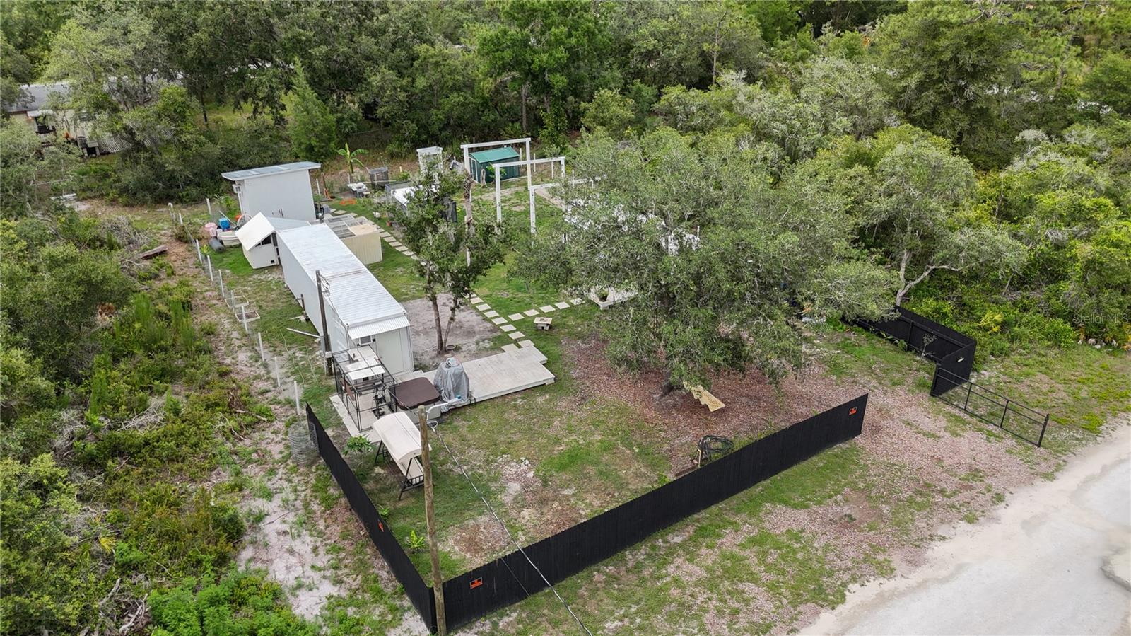 Welcome to your private oasis in a quiet neighborhood close to I-75 and easy access to Tampa. This land is FULLY CLEARED, did NOT FLOOD during recent hurricanes, has a WELL and 200 amp LIGHT POLE!! Fully FENCED with a 6 ft, pressure treated, privacy fence in front and wire in back. and ready to put your mobile, tiny home, or even build! Enjoy peach, pecan, banana, apple, and plum FRUIT TREES. There are 2 ADJACENT LOTS to this property that can be purchased as well. Each is .25 acre also, providing .75 acre if all three lots are purchased- call agent for details. Don't miss your opportunity to own this ready to go lot today!!