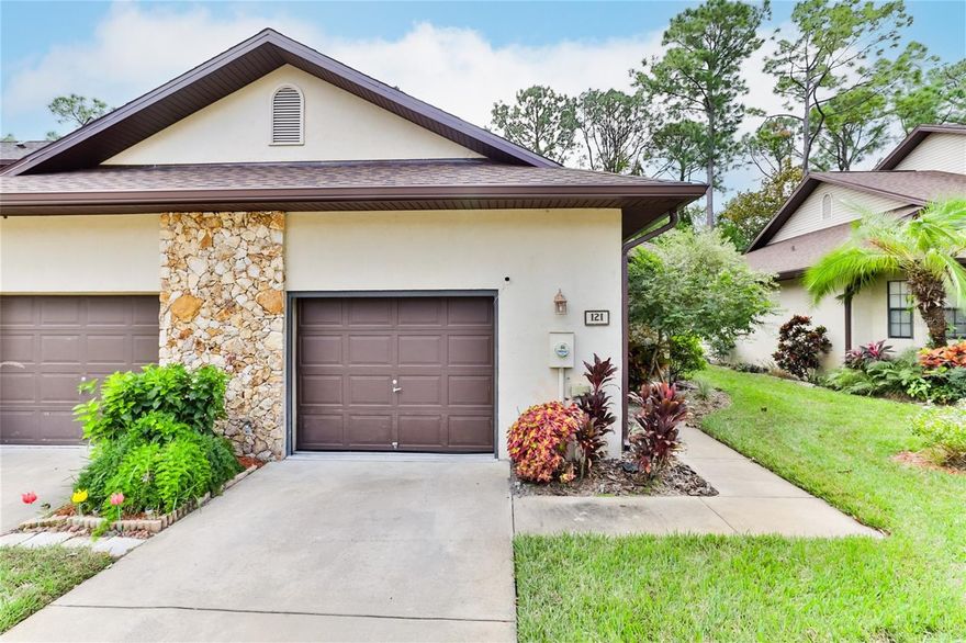 Beautifully updated home tucked away in a quiet, hidden section of the well-maintained Sunset Pines community. This low-maintenance property features wood-look tile flooring throughout, weatherized window treatments, modern lighting, and an upgraded master shower. The primary suite includes a spacious walk-in closet accented by a charming bay window that fills the room with natural sunlight. A cozy, romantic fireplace adds warmth and ambiance on cooler winter nights while helping reduce electric usage. The one-car garage offers a dedicated laundry area and convenient attic access for extra storage. Step outside and enjoy the spacious lanai, where you can relax each morning with coffee or tea while watching rabbits, birds, and the peaceful natural surroundings. This townhome is also just footsteps from the sparkling heated pool, offering year-round enjoyment. Exterior improvements include a new roof (2023) and fresh exterior paint (2024)—both covered by the HOA along with landscaping and common-area maintenance. All major appliances have been annually serviced under extended warranty, and Whirlpool kitchen appliances are included. Sunset Pines is an established, peaceful community with long-term homeowners, many of whom are retirees or seasonal residents who appreciate a quiet, respectful environment with minimal noise and activity. Come make your permanent residence feel like a vacation home and primary retreat all in one. Ideally located minutes from the Daytona International Speedway, Daytona Beach, Ponce Inlet, Tanger Outlets, Volusia Mall, restaurants, and grocery stores.
