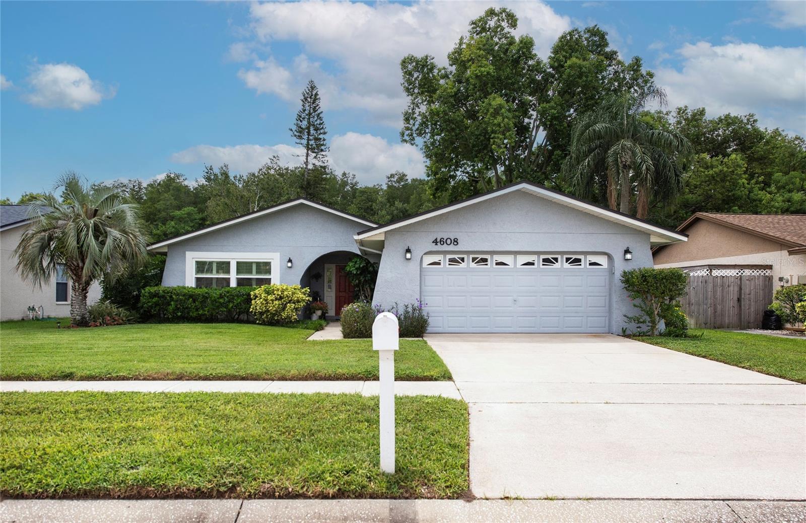 One or more photo(s) has been virtually staged. Welcome to this beautifully maintained home, nestled in the most peaceful waterfront setting. Enjoy pretty water views from your private backyard, perfect for nature lovers and those seeking an outdoor oasis. This beautiful home is located in the desired Beacon Meadows community in the North Tampa Carrollwood area. The spacious floorplan has nearly 1,800 square feet of living space, with 3 bedrooms, 2 bathrooms, 2 car garage, storage shed & a huge fenced in yard. Roof & HVAC (2018), New windows (2021), updated hall bathroom, plantation shutters and all appliances included. Featuring a large living room, dining room & separate family room, all with luxury vinyl flooring. The amazing eat-it kitchen has been updated with quartz countertops, real wood maple cabinetry, stainless steel appliances, closet pantry, breakfast bar & lots of counter space to please the pickiest chef. The adjoining family room might be the best room in the house with lots of room for comfortable furniture, a cozy, wood burning fireplace, skylights that let in the natural light and french doors that lead to the backyard. Step outside to the open patio area, have a seat, this is the perfect spot to relax & unwind while surrounded by the tranquil, natural setting. You might even see an osprey across the water or a turtle swim by, it's a natures paradise in your own backyard. There's no HOA fee's in this community and the home sits in flood zone X. Beacon Meadows Park is just down the street, with a playground, basketball court, fitness equipment & walking trail. This home is move in ready, beautifully maintained with original owner and sits in a PRIME LOCATION. Call for your private showing today.