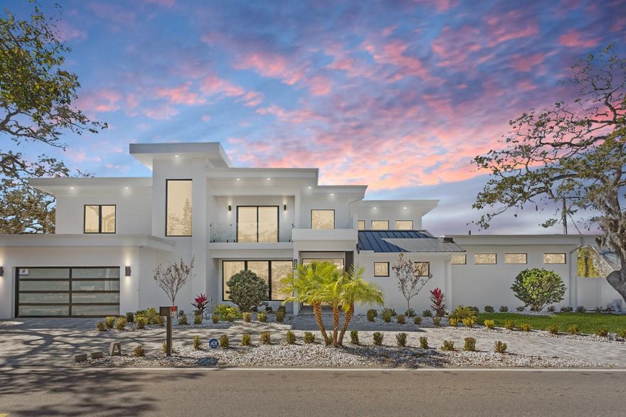 2089 Arlington Street, where architecture meets light, space, and coastal elegance, this newly constructed contemporary residence offers 4,231 square feet of living space and 5,284 total square feet, thoughtfully designed with architectural precision and warm minimalism. Completed in January 2026, this striking two-story home sits on a rare double corner lot and features 5 bedrooms and 6 bathrooms, delivering both scale and sophistication.
The open-concept interior is defined by dramatic 22-foot ceilings, expansive custom windows and doors, and an abundance of natural light throughout. The main level is anchored by a statement chef’s kitchen imported from Italy, showcasing custom cabinetry, luxury built-in appliances, a Sub-Zero refrigerator, premium hardware, and top-quality London Fog granite countertops. A concealed secondary kitchen provides additional functionality and discretion, ideal for entertaining and catered events.
The primary suite is conveniently located on the ground floor, offering a private retreat with serene views and a spa-inspired bath. Additional bedrooms are generously sized, each with access to a full bathroom. A custom glass wine room adds a refined architectural focal point, while a loft-style family/media lounge on the second level overlooks the main living area, enhancing the home’s open, airy feel.
Designed for seamless indoor–outdoor living, oversized sliding doors open to a private resort-style setting with a custom pool and spa, covered terrace, and enhanced landscaping. Architectural exterior lighting highlights the home’s clean lines and modern façade after sunset.
Quality and performance are paramount: both levels are constructed of solid concrete block, and three independent HVAC systems serve the ground floor, primary suite, and second floor for optimal comfort and efficiency. Additional features include a private elevator, and all custom-made windows, doors, and cabinetry throughout—evidence of meticulous attention to detail in every finish.
Ideally located for effortless travel and coastal lifestyle enjoyment, this home is approximately 12–15 minutes from Sarasota–Bradenton International Airport, about 1 hour 10 minutes from Tampa International Airport, 10–15 minutes to Lido Key, and about 15 minutes to Siesta Key, world-renowned for powder-white sand and Gulf sunsets.
Situated outside of a flood zone, this exceptional residence presents a rare opportunity to own a custom-built contemporary home where design, craftsmanship, location, and lifestyle converge.