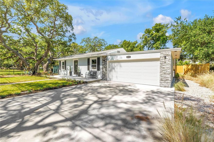 The Unicorn Property of St. Petersburg—fully renovated, ideally located in a non-flood, non-evacuation zone, and just one mile to Madeira Beach.

Situated on a corner lot in Unincorporated St. Petersburg, this property offers rare flexibility, including potential for short-term rental use and space for boat or RV parking.

Inside, nearly 1,800 square feet unfolds with intention and ease. The home lives beautifully, anchored by a stunning 12-foot custom bar with built-in bar fridge—a true centerpiece designed for gathering and entertaining. The flow is effortless, the finishes cohesive, and every detail thoughtfully curated—from all-new flooring and interior doors to a beautifully redesigned kitchen featuring KraftMaid cabinetry paired with striking quartz countertops.

Fully renovated baths include a serene primary suite with a soaking tub that invites you to slow down and stay awhile.

Behind the design, the value continues. A new roof (2024), new windows and sliders (2025), new tankless water heater (2025), new appliances (2025), new pool pavers (2025), new outdoor kitchen and fireplace (2026), new HVAC (2026), and a brand-new 2-car garage (2026) offer a level of confidence that is increasingly hard to find.

Designed for exceptional outdoor living, this private corner lot offers multiple distinct outdoor living zones, creating a true extension of the home. A beautifully screened pool enclosure with new pavers and outdoor shower provides a resort-style retreat, while a separate outdoor kitchen and fireplace gathering space invites effortless entertaining. In addition, two separate fenced areas offer flexibility for pets, play, or garden spaces—an uncommon and highly functional feature.

Set beside a quiet, open green space shaded by majestic, generations-old oaks, the setting feels natural, private, and unexpectedly serene—yet remains just minutes from the Gulf beaches, dining, and everything that makes this area so desirable.

At this price point, it is rare to find a home that delivers location—just minutes to the Gulf Beaches, Downtown St. Petersburg, Tampa International Airport, and St. Pete-Clearwater Airport—along with condition, flexibility, and lifestyle in one complete package.

This is not just another home—this is the one buyers have been waiting for.
Add this home to your MUST-SEE list today.