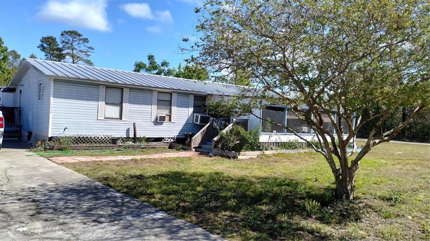 BEST PRICED home on the market! Back on the markwt and better than ever! Seller has had the entire home replumbed. This home is ready for a new owner!. Doesn't living in a quiet, peaceful community sound amazing to you? This property is unique. This 3 bedroom, 2 bath manufactured home has a split open floor plan, large front screen patio and an oversized kitchen perfect for the cooking loving chef. You'll have plenty of cabinet space for all your cooking gadgets and gizmos. Step out the sliding glass door down into the 1 bedroom, 1 bath in law suite complete with a small kitchen and living room. This is an excellent deal and will make someone a wonderful family home. Single wide next door is also for sale separately for $69,000.