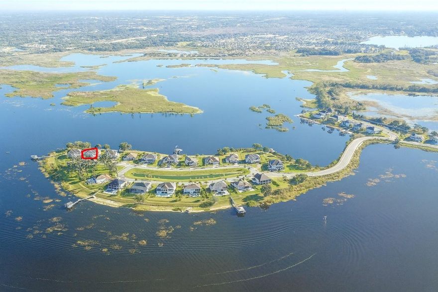 LUXURY ISLAND HOME IN POPULAR GATED COMMUNITY.  Experience modern lakefront luxury in Emerald Point, an exclusive gated island of only 28 homes within the desirable Hickory Hammock community, offering a rare blend of luxury, privacy and premium lakefront living. Perfectly positioned on Johns Lake, this contemporary two-story home showcases clean architectural lines, sophisticated finishes, and breathtaking water views, offering the ultimate in Florida living. Privacy and serenity are exceptional with wide lake views from nearly every room and a charming, landscaped park with towering oaks directly across the street. From the moment you enter, a dramatic two-story foyer with upgraded crystal light fixtures and a striking clear view of the lake sets the tone for this modern masterpiece. The formal dining area flows seamlessly into the expansive great room, where an open concept design, stacked stone accent wall, and a rear wall of stackable sliding glass doors creating a true indoor-outdoor living experience. The oversized gourmet kitchen is a chef’s dream, featuring dual islands, pot filler, built-in side-by-side stainless steel refrigerator and freezer, double ovens with convection, built-in microwave, and a dedicated wine and beverage cooler. White shaker cabinetry with illuminated glass inserts, crown molding, quartz countertops, glass tile backsplash, and an oversized walk-in pantry elevate the space. The breakfast nook is perfectly positioned to capture tranquil lake views with every meal. The main level offers a thoughtfully placed half bath for guests, along with a private guest suite featuring sliding doors to the covered lanai and an ensuite bath, ideal for extended stays or multigenerational living. Upstairs, modern glass and stainless-steel railing lead to a spacious bonus room with a full wet bar and additional wine and beverage cooler. This impressive entertaining space opens to a generous balcony with sweeping, unobstructed views of Johns Lake. A convenient laundry room with LG washer and dryer and a second half bath add to the home’s functionality. The primary suite is a serene lakefront retreat, boasting dual walk-in closets, private balcony overlooking Johns Lake, and a spa-inspired ensuite with oversized walk-in shower with rain shower head, garden tub, and dual quartz vanities. Three additional upstairs bedrooms include generous closets, ceiling fans, and either ensuite or Jack-and-Jill baths with tile flooring, quartz counters, and tub/shower combinations; perfect for family or guests. Modern conveniences abound, including a Nest home system, motorized rolling shades, whole-house water filtration with reverse osmosis, and an oversized 3-car garage. The east-facing rear yard offers approximately 102 feet of lake frontage, thoughtfully oriented to avoid the harsh afternoon sun while maximizing shimmering water views throughout the day. Residents of Hickory Hammock enjoy resort-style amenities including a zero-entry pool, clubhouse, fitness center, tennis and volleyball courts, fishing pier, playgrounds, walking trails, and a dog park. Located just minutes from historic Downtown Winter Garden, Winter Garden Village, area attractions, Disney, and Orlando International Airport, this residence perfectly blends contemporary design, lakefront luxury, and everyday convenience. Schedule your private showing today and experience lakefront sophistication at Emerald Point at Hickory Hammock.