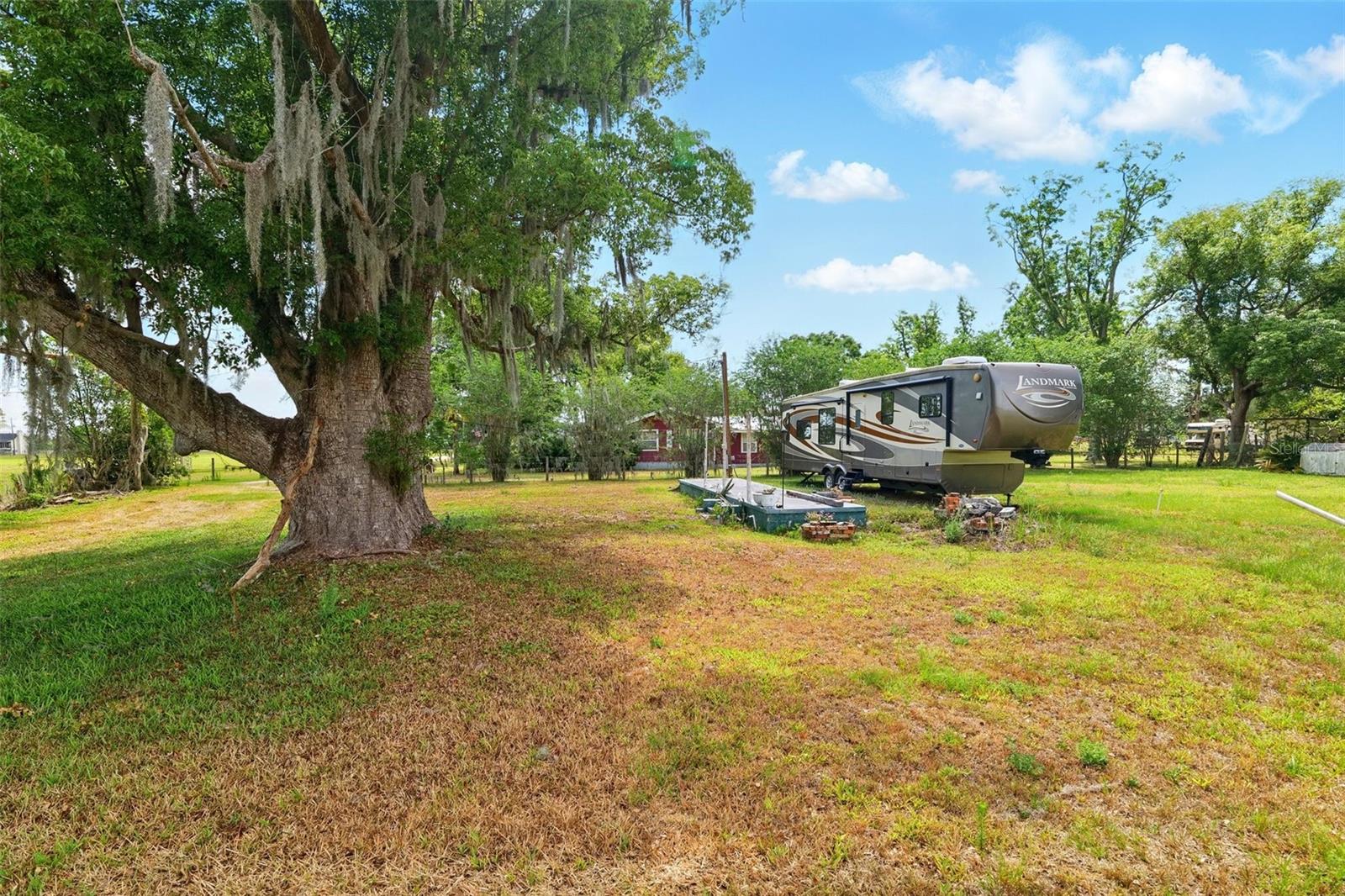 Welcome to 3511 and 3535 E. Keysville Rd. a rare opportunity to live the peaceful life you’ve always envisioned! This high and dry 7.15-acre property in Lithia is made up of TWO SPACIOUS PARCELS—one measuring 6.13 acres and the other 1.02 acres, currently featuring an RV. Surrounded by nature and tucked away in a serene countryside setting, this land offers the perfect blend of tranquility and potential. With ample space to create your ideal lifestyle, the possibilities are truly endless. The property comes fully equipped with a well, septic tank, electricity, a storage shed, and a barn with two doors, giving you a head start on your vision. The serene countryside setting provides both privacy and beauty, surrounded by nature yet just a short drive from Hillsborough County, Riverview, Plant City, Brandon, Lakeland, St. Petersburg, and Clearwater. An added bonus is the included 2011 Heartland Augusta by Landmark RV—perfect for temporary living. This well-maintained RV includes: Full body paint and air ride hitch, Onan propane generator, Island kitchen with stainless steel appliances, Washer/dryer, Arctic Package, Curved glass shower and glass bowl sink, King-size bed, 4 slides, No pets, No smoke—like new condition. Whether you're bringing animals, or simply escaping to a quieter lifestyle, this land is ready for you. No HOA, no restrictions—just freedom and opportunity. Easy to view—visit the site anytime. Don’t miss out on one of Lithia’s best properties. Come see the potential and make your dream a reality!