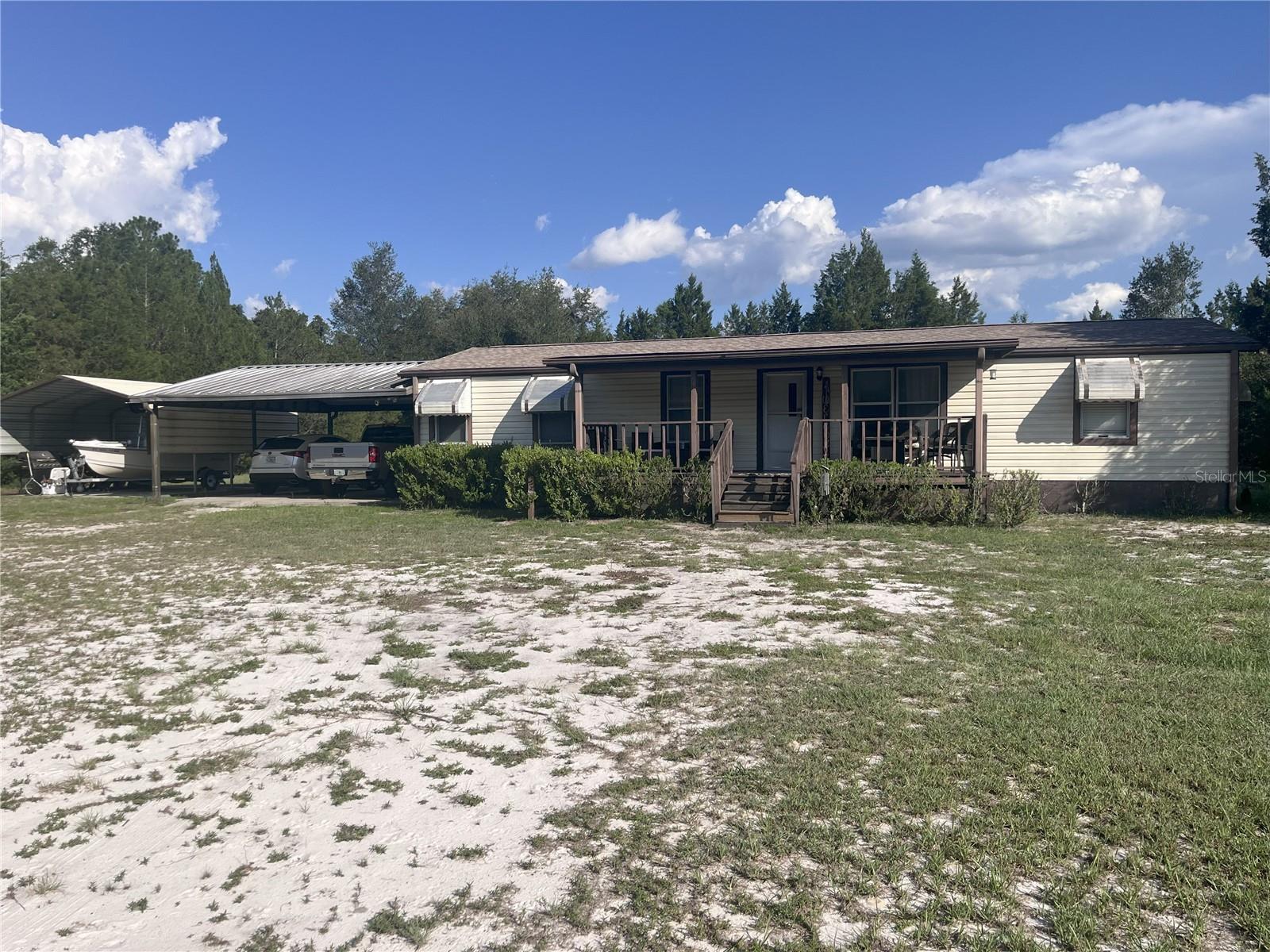 ** Country Living at Its Finest – 13880 SE 47th Street Rd, Ocklawaha, FL 32179
Escape the hustle and embrace tranquility at this charming 3-bedroom, 2-bath double-wide mobile home nestled on a sprawling 3.01-acre lot in the heart of Ocklawaha. Surrounded by mature landscaping and backing up to the Ocala National Forest, this property offers the perfect blend of privacy and nature.
** Property Highlights
Spacious Layout: 1,248 sq ft with an open floor plan and split bedrooms
Outdoor Living: Enjoy peaceful mornings and relaxing evenings on the front and rear porches
Modern Comforts: Central A/C, water softening system, and newer appliances, Plenty of Parking: Two carports with space for up to 4 vehicles
Storage Galore: Includes a shed and inside utility room for all your needs
** Land Features
Zoned for horses.
Flat, usable land with dirt road access
Well and septic system in place
** Location Perks
Minutes from Lake Weir and outdoor recreation
Easy access to Hwy 40 and local amenities
Nearby schools include Lake Weir High and Middle School
Whether you're looking for a peaceful retreat, a homestead opportunity, or simply more room to roam, this property delivers. Ready to live your country dream? Call to see this peaceful place to call yours!!!
