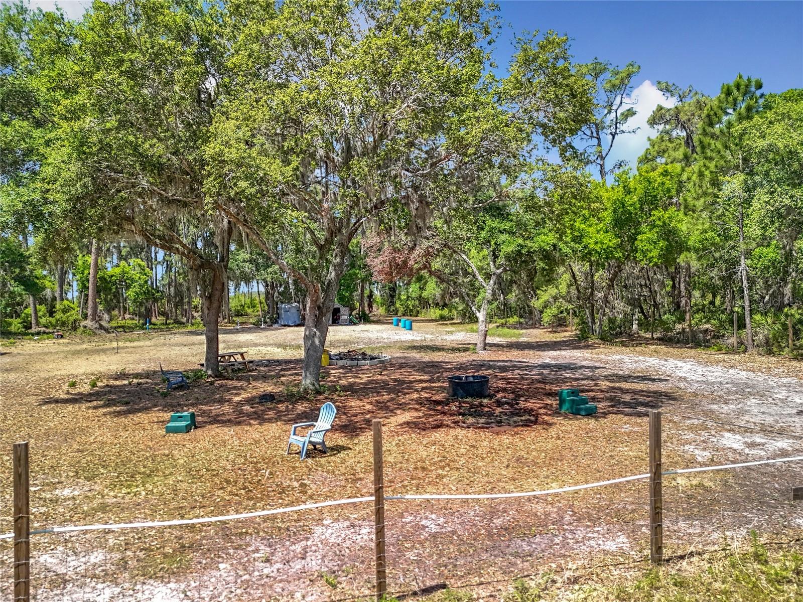 IMPROVED 2.8 +/- LAND! Not going to find a better location and amenities at this price! WELL and ELECTRIC already on site. Cleared with some large oak and pines for shade but you decide what remains. Improved pond on property does have some fish and will make an incredible center piece. Plenty of high and dry land for your build! Bring the HORSES, 4-WHEELERS or the BINOCULARS and HIKING BOOTS! Through the back gate of this propperty and directly onto the trail of the Emerald Island Marsh Conservation Area. Rear portion of property is fenced. Storage shed conveys with the property as does the 2 car-carport on concrete slab and the RV-carport for parking. 5 minutes to the Ocala National Forest! 9 minutes to grocery, pharmacy, restuarants, fuel, etc! Easy commute to the tollroad 429 and Orlando Metro.