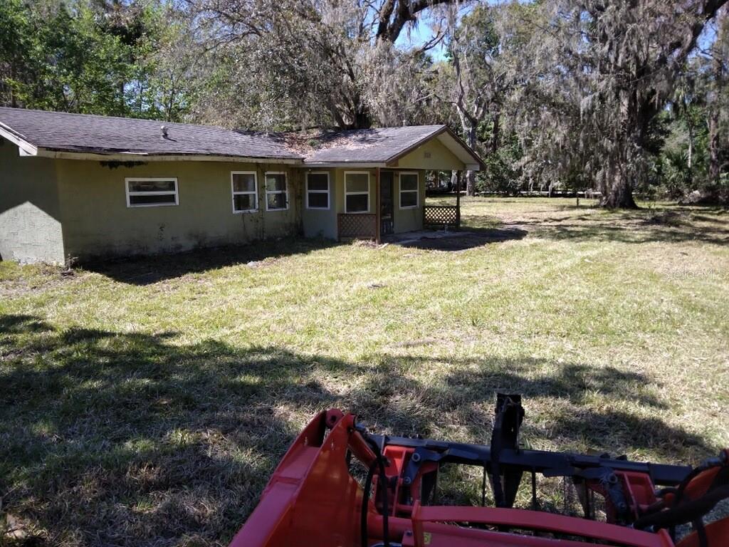 Charming opportunity for renovators and investors! Property has been just bushhogged and looks great. This home in need of major renovation sits on a .46-acre lot between two convenient roadways, offering easy access and a unique layout. The property boasts a spacious yard with mature trees, providing ample space for landscaping, gardening, or future expansion. Its location offers versatility and potential for a custom transformation. A perfect blank slate to create your dream home or an excellent investment opportunity in a prime setting. This Golf cart community is old Homosassa Springs, The Shed, Florida cracker monkey bar, freezer, from Music entertainment to biking to kayaking and lots of Golfing! This is a lovely area to call home. Don't miss the chance to unlock this property's full potential!
